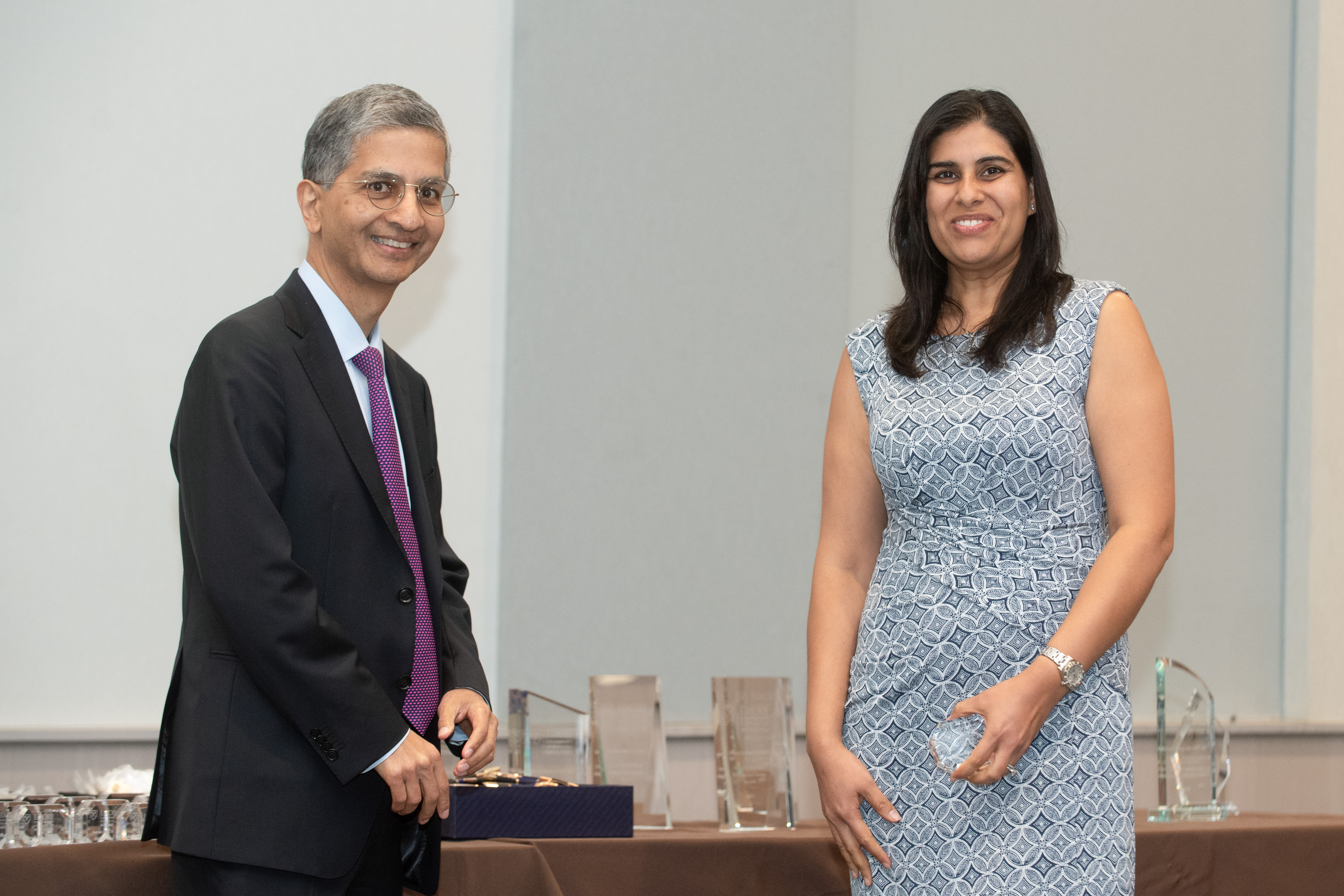 Faculty member receiving glass award from the dean