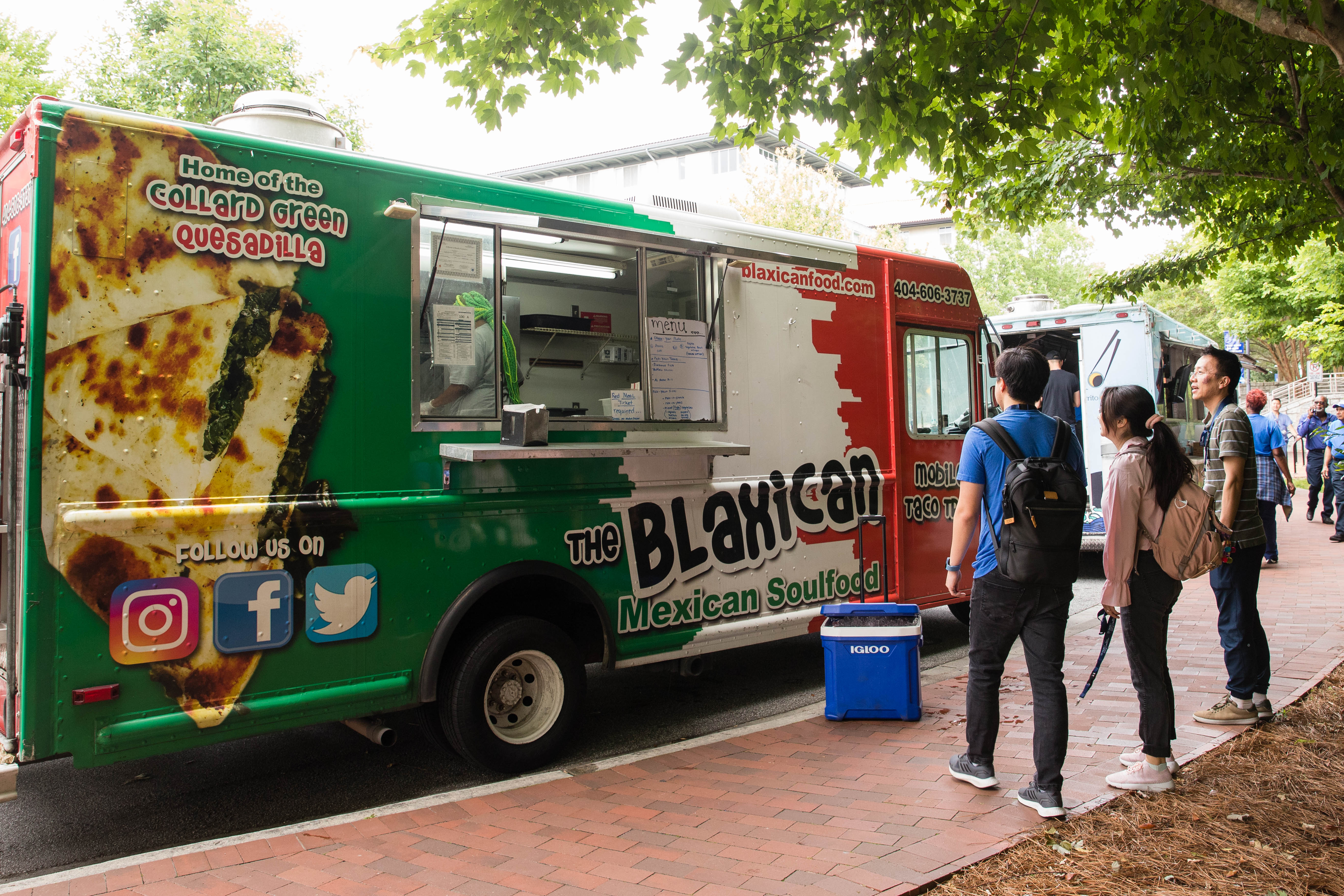 People stand at a food truck