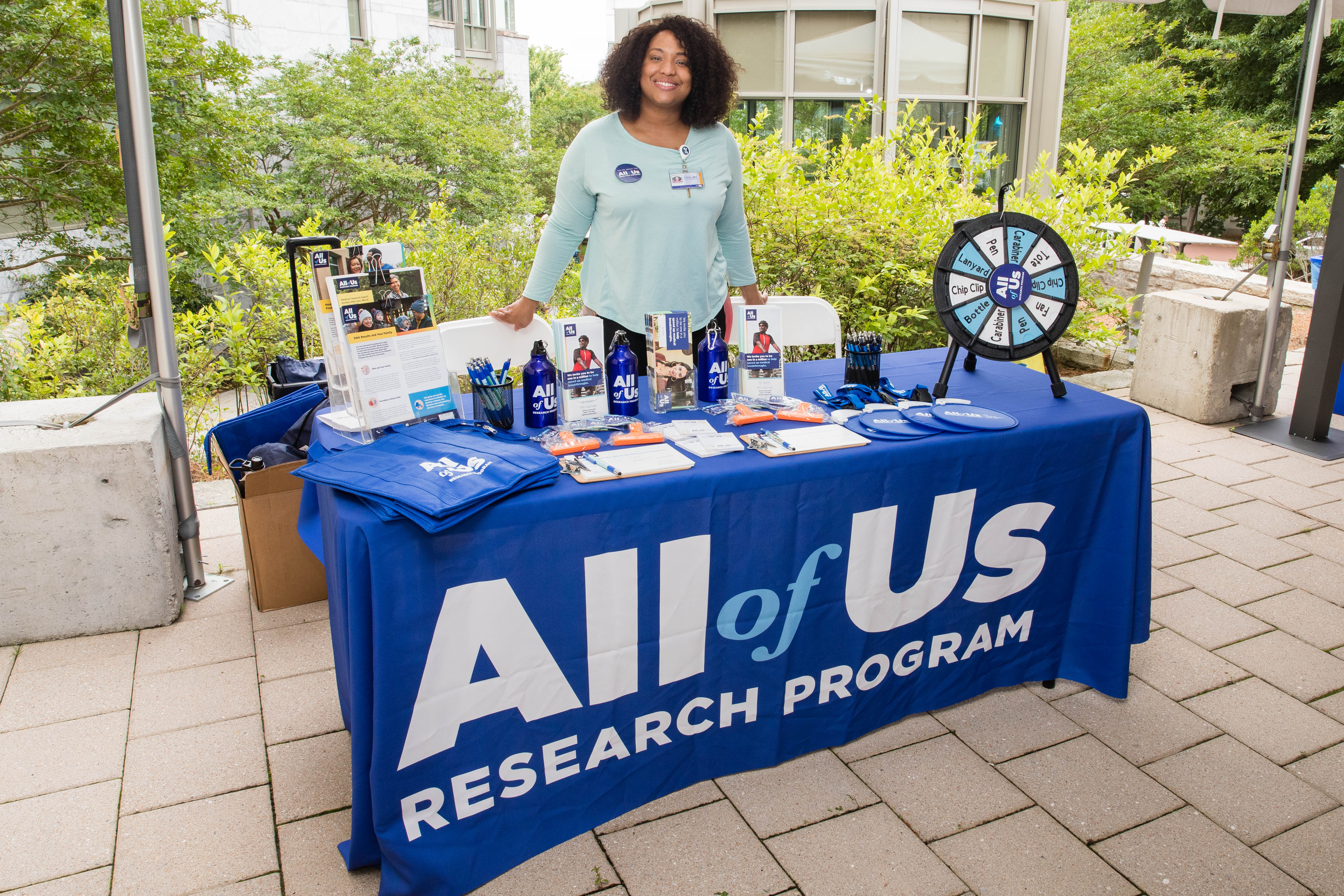 Woman stands at her table during a resource fair