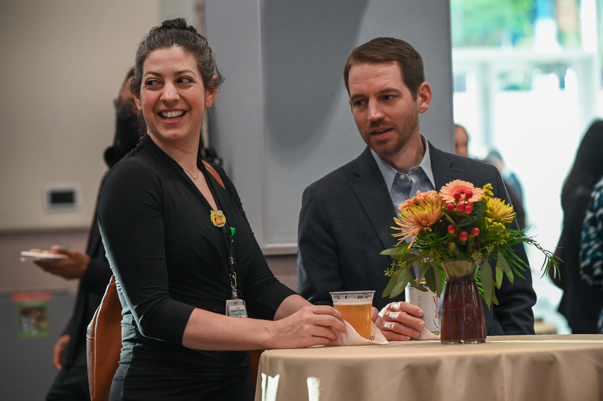 Man and woman stand at a table during ceremony.