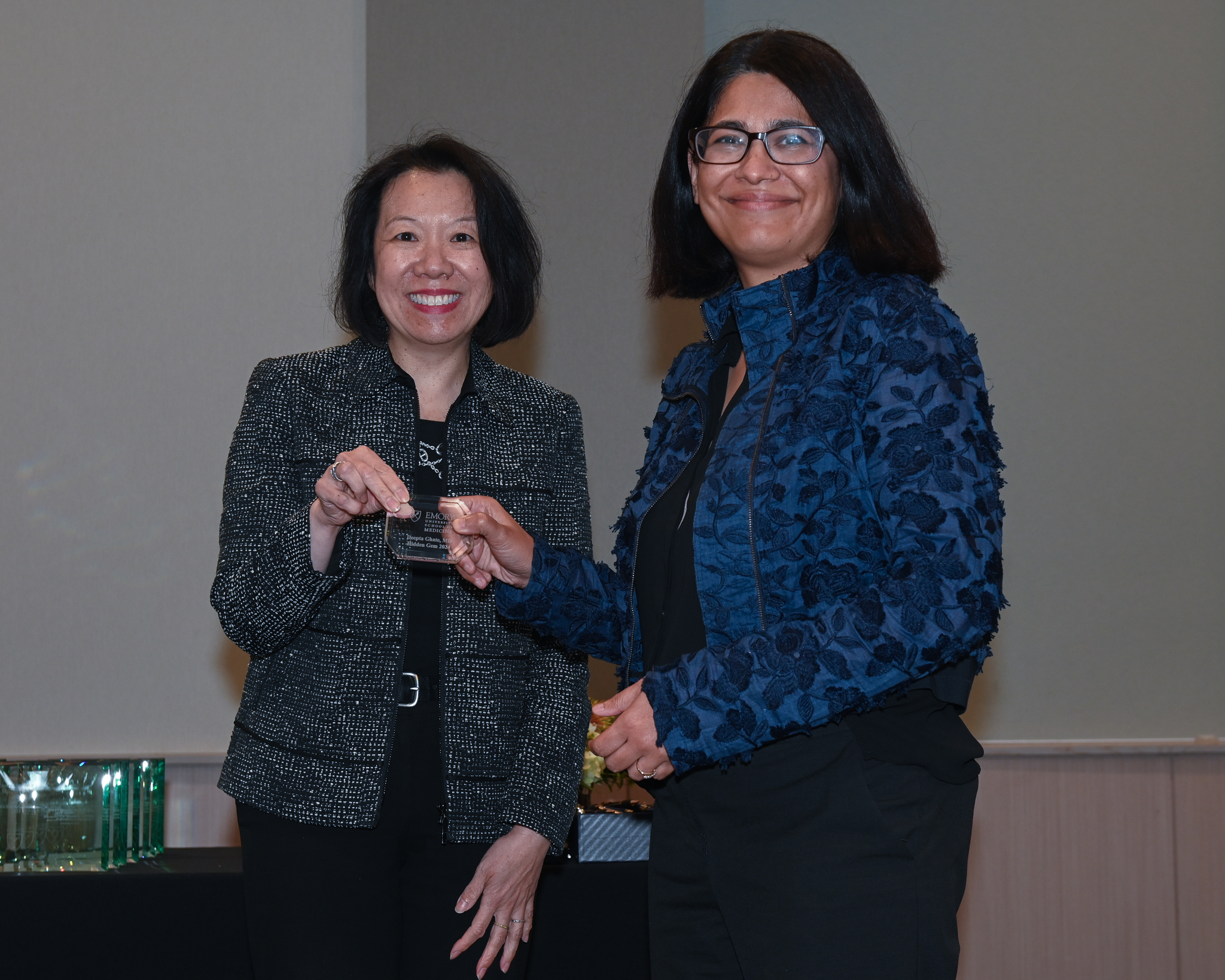 Faculty member receiving glass award from the dean