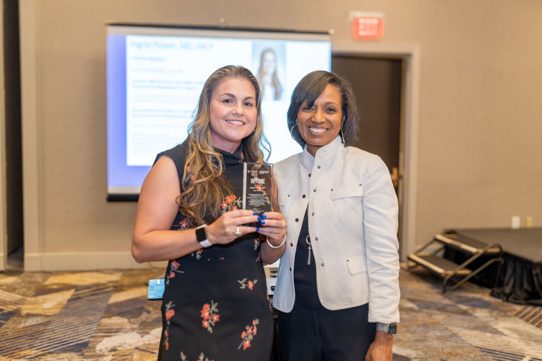 Jada Bussey-Jones stand with a Grady Award winner