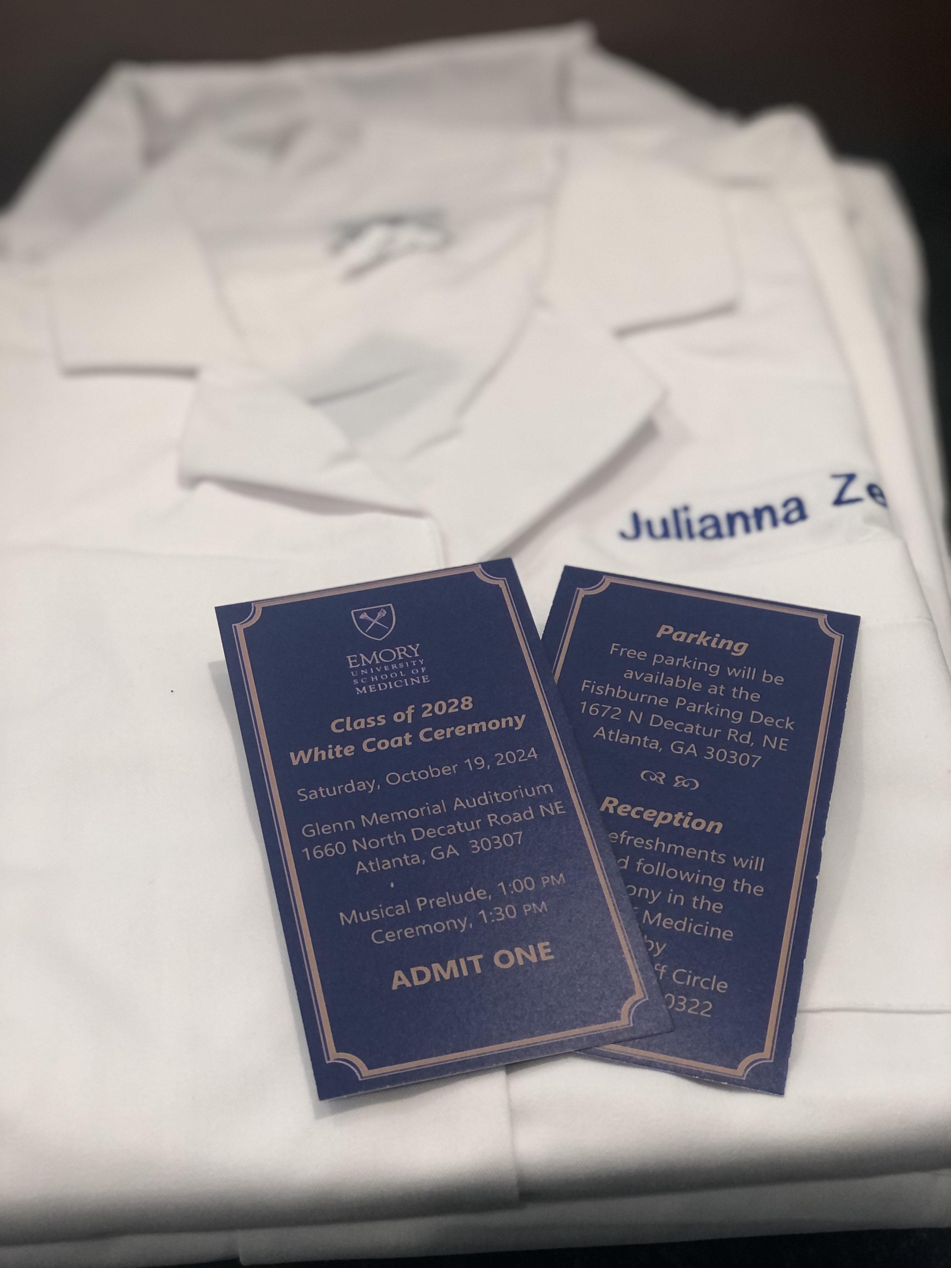 white coat with blue tickets on top