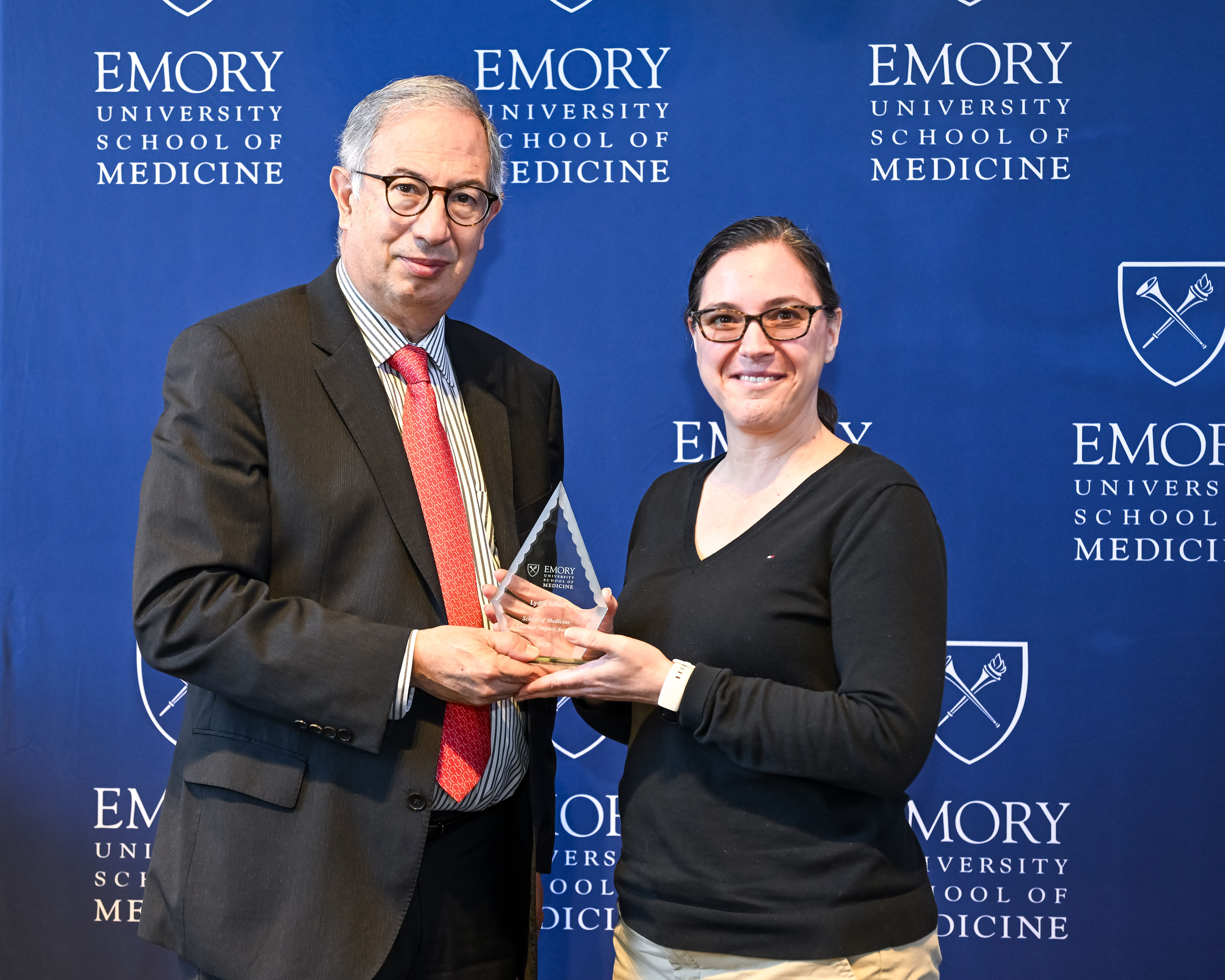 Lydia Soleil accepting her award with interim Dean del Rio