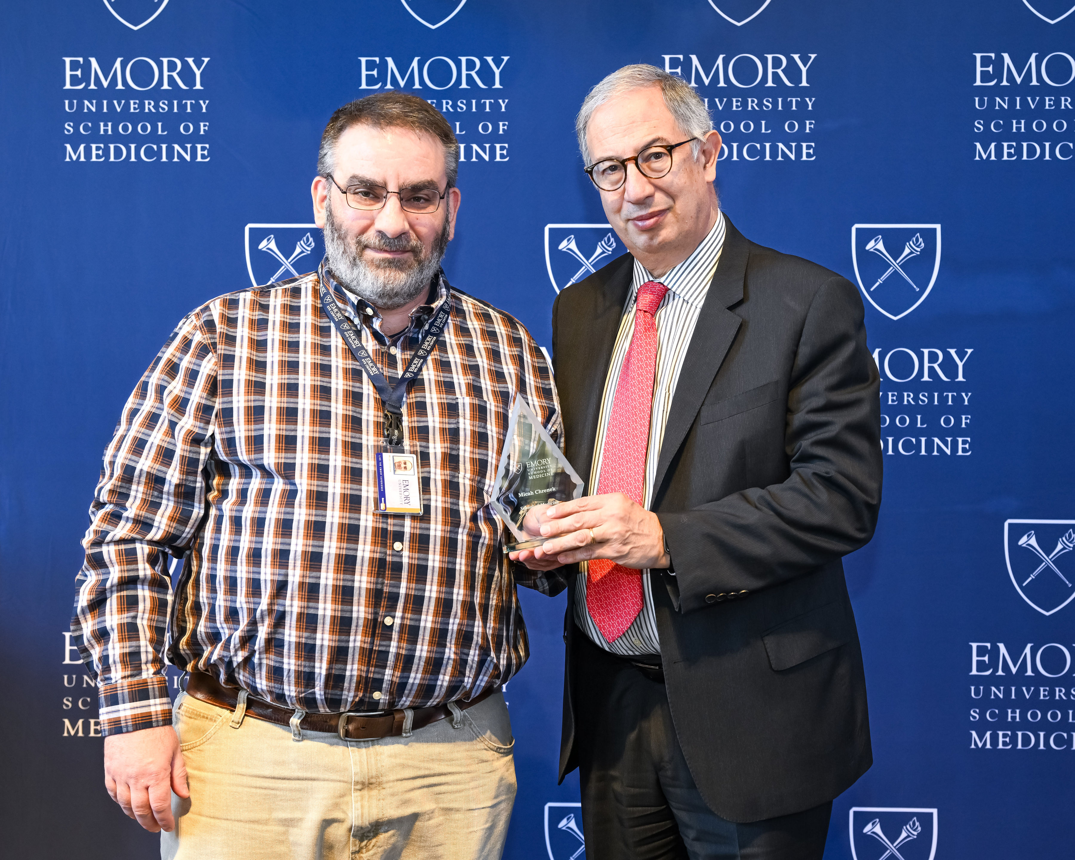 Micah Chrenek accepting his award with interim Dean del Rio