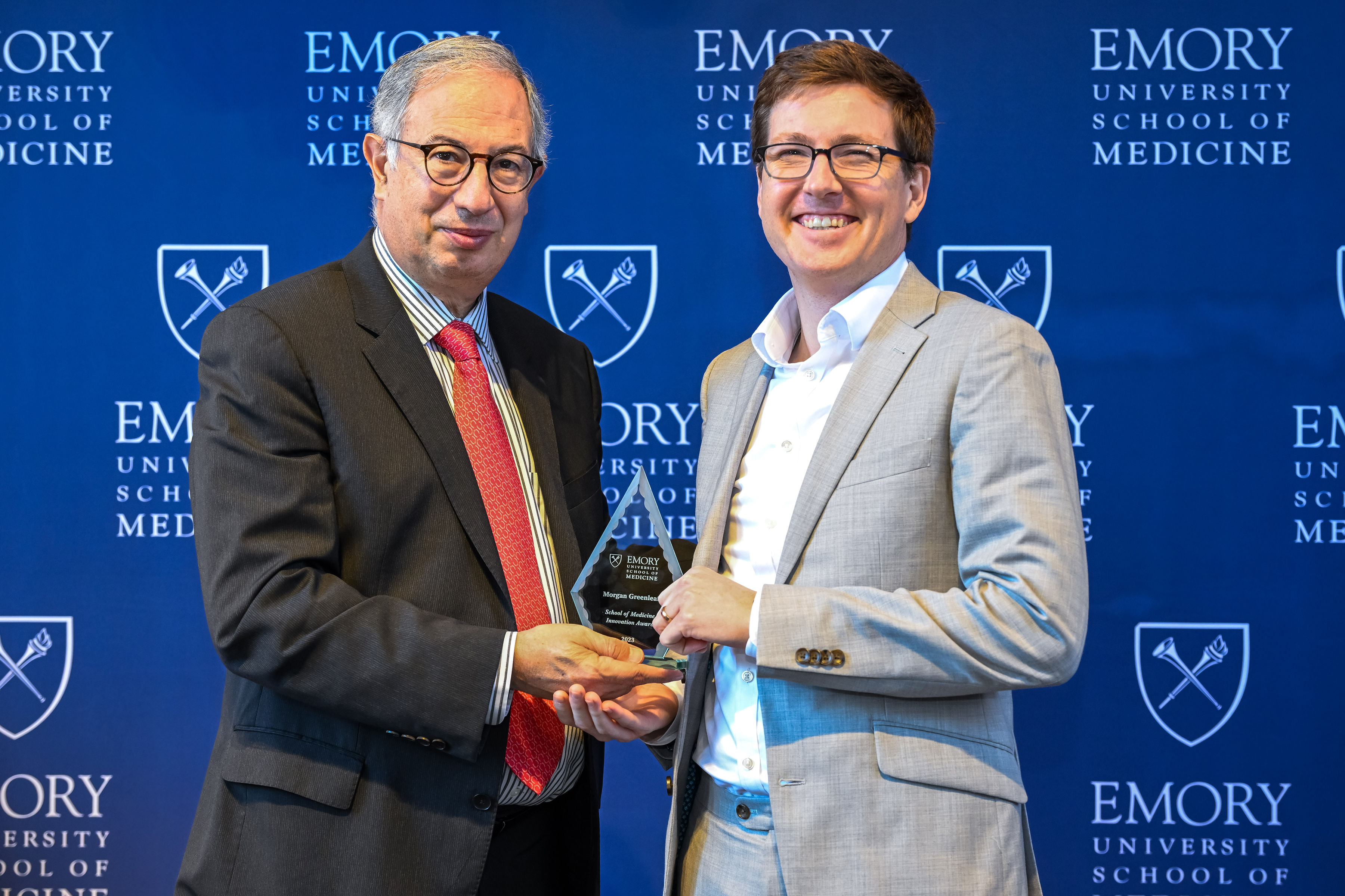 Morgan Greenleaf accepting his award with interim Dean del Rio