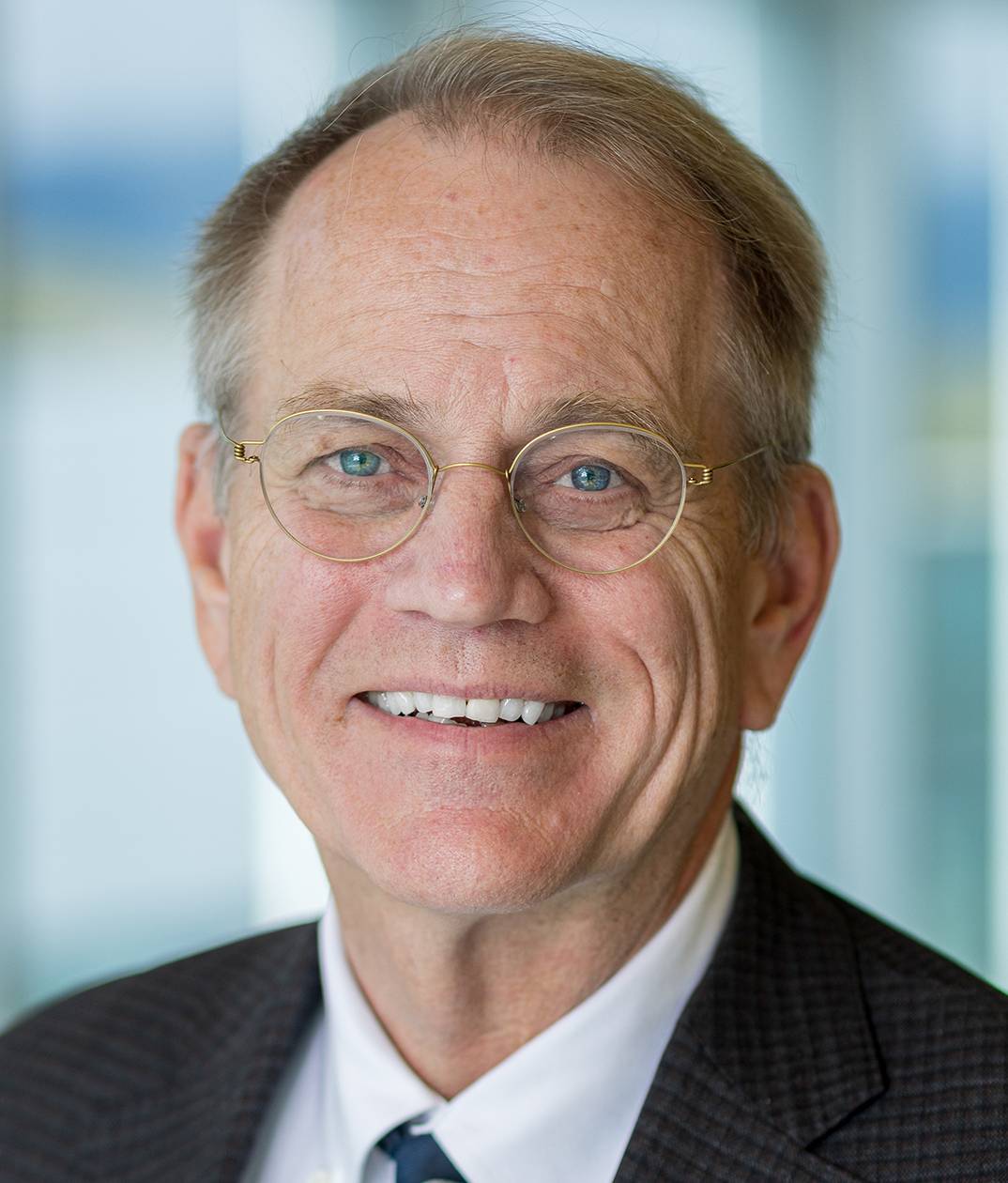 man with glassess and wearing a suit