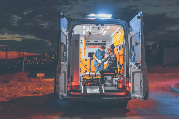 Stock image of ambulance with two people inside.