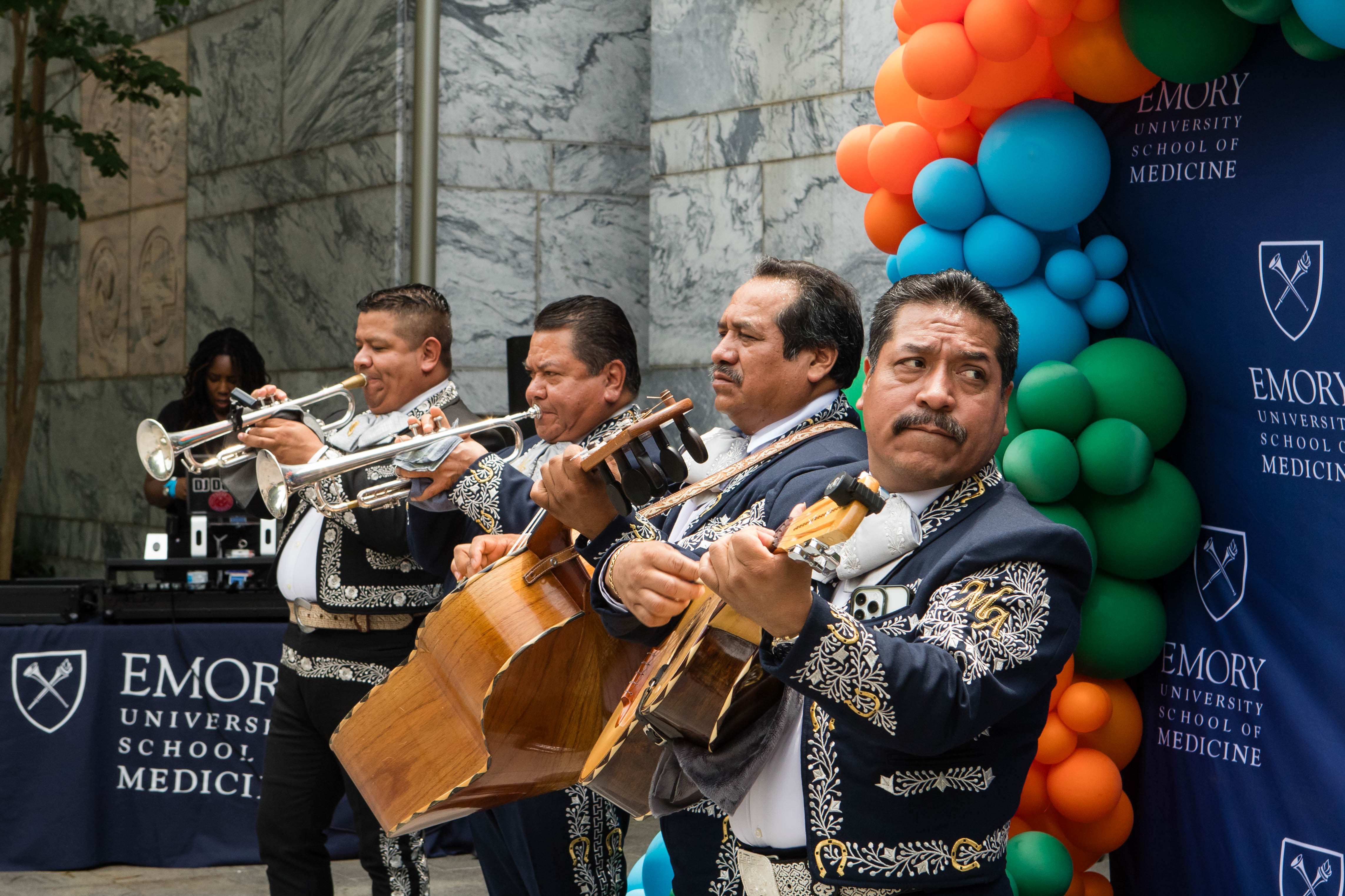 Mariachi band performing at event. 