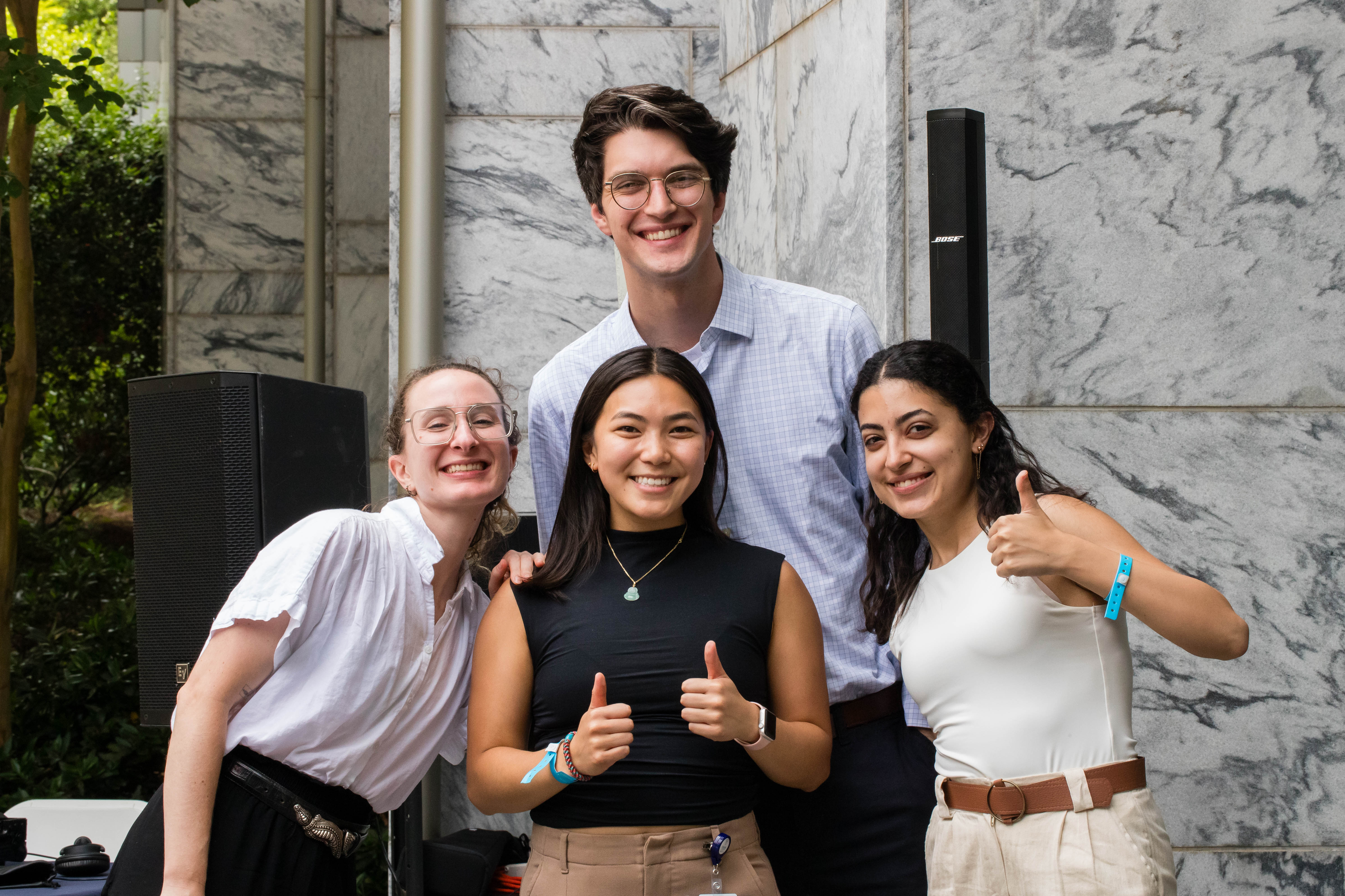 Four people smile for a photo. 