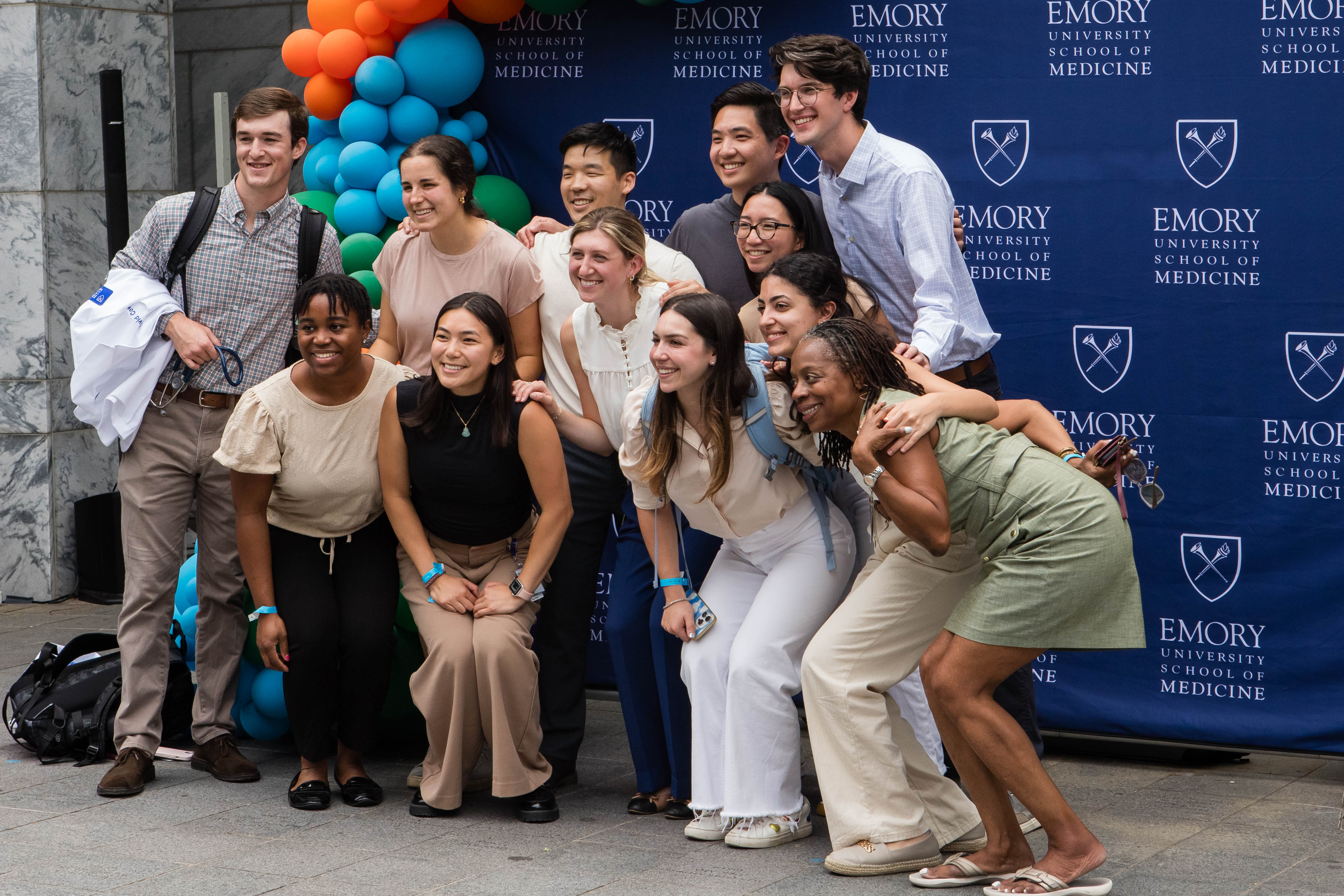 Group of people smile for group photo.