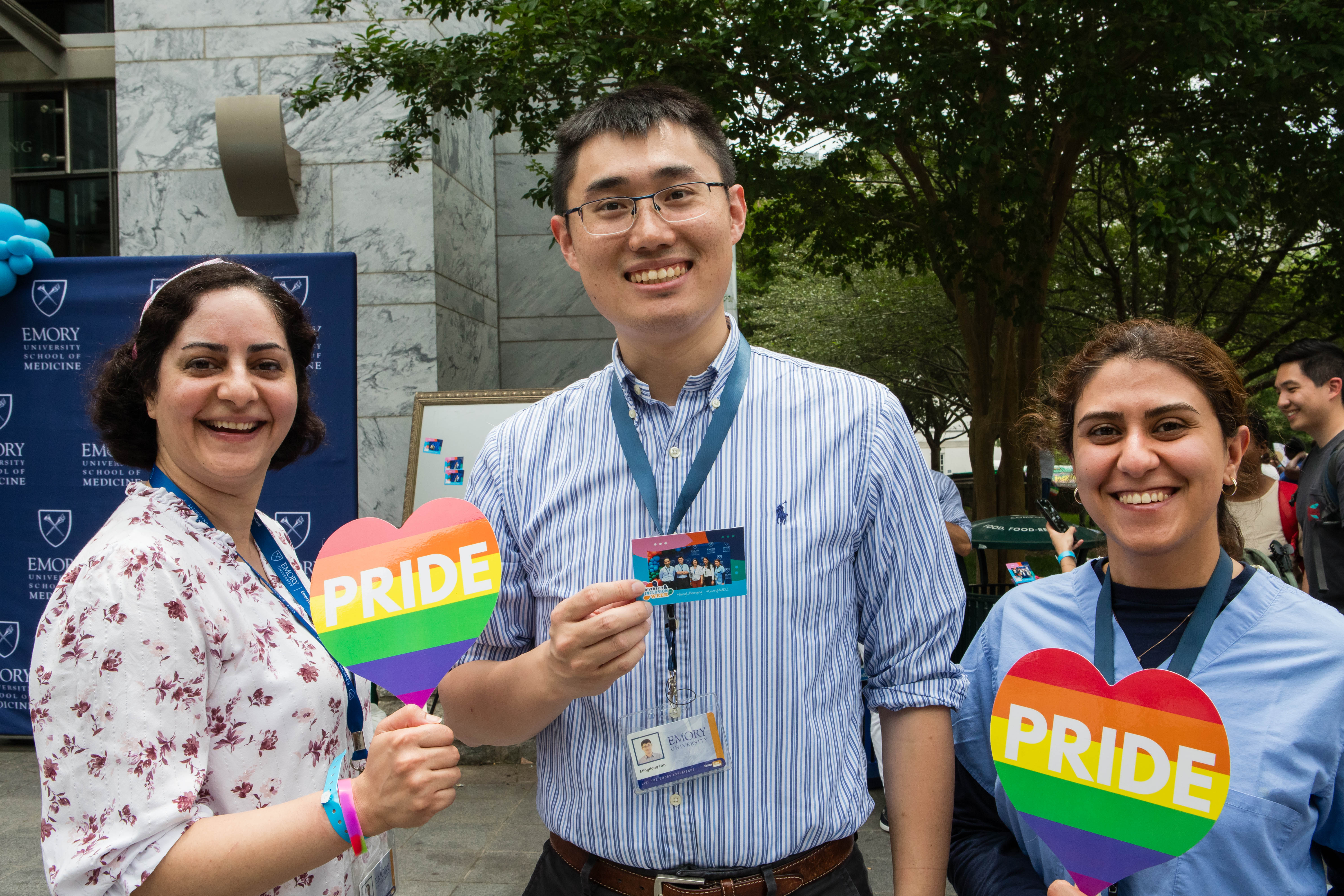 Three people smile for a photo. 