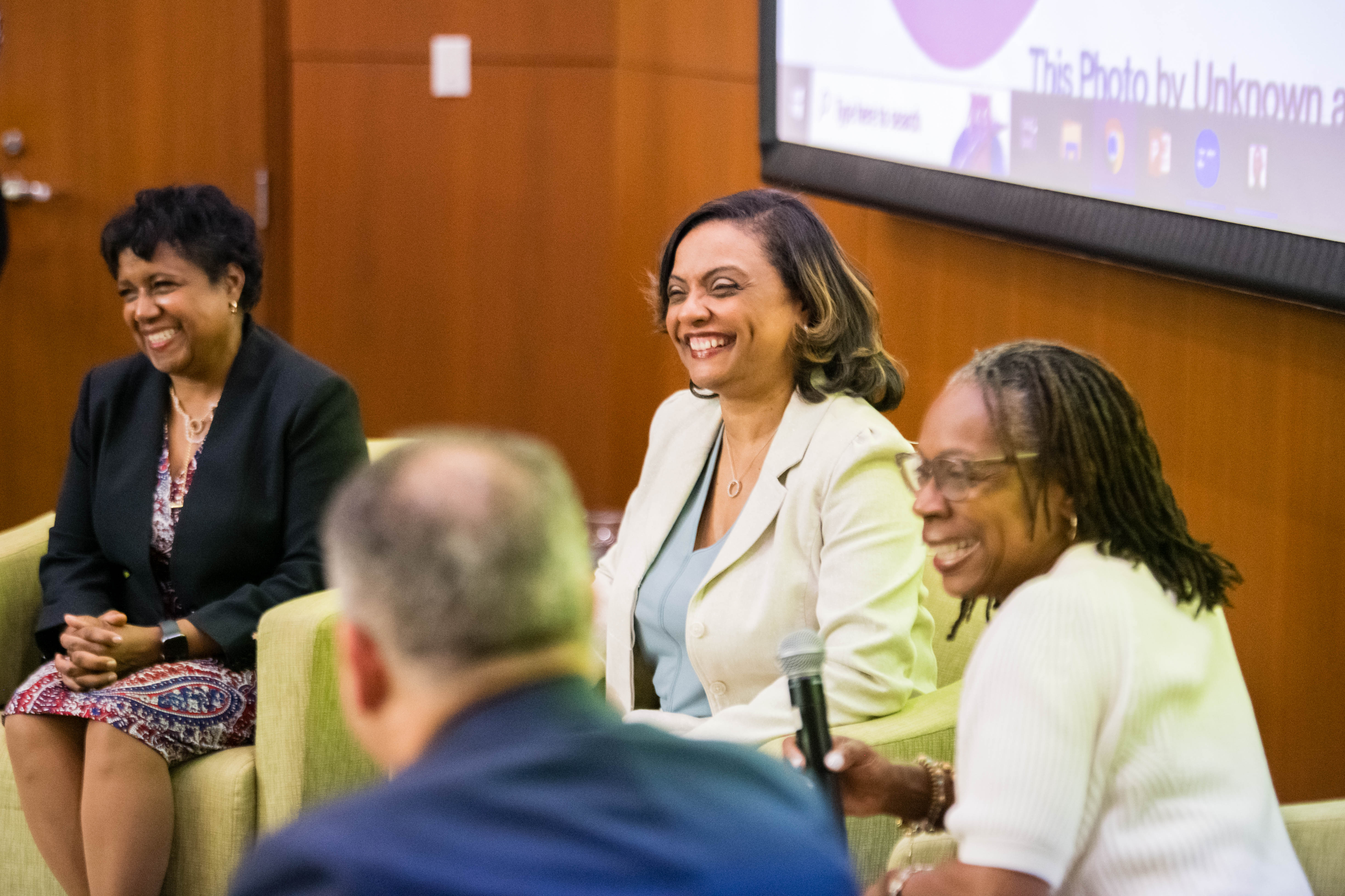 Four people engage at a panel session.