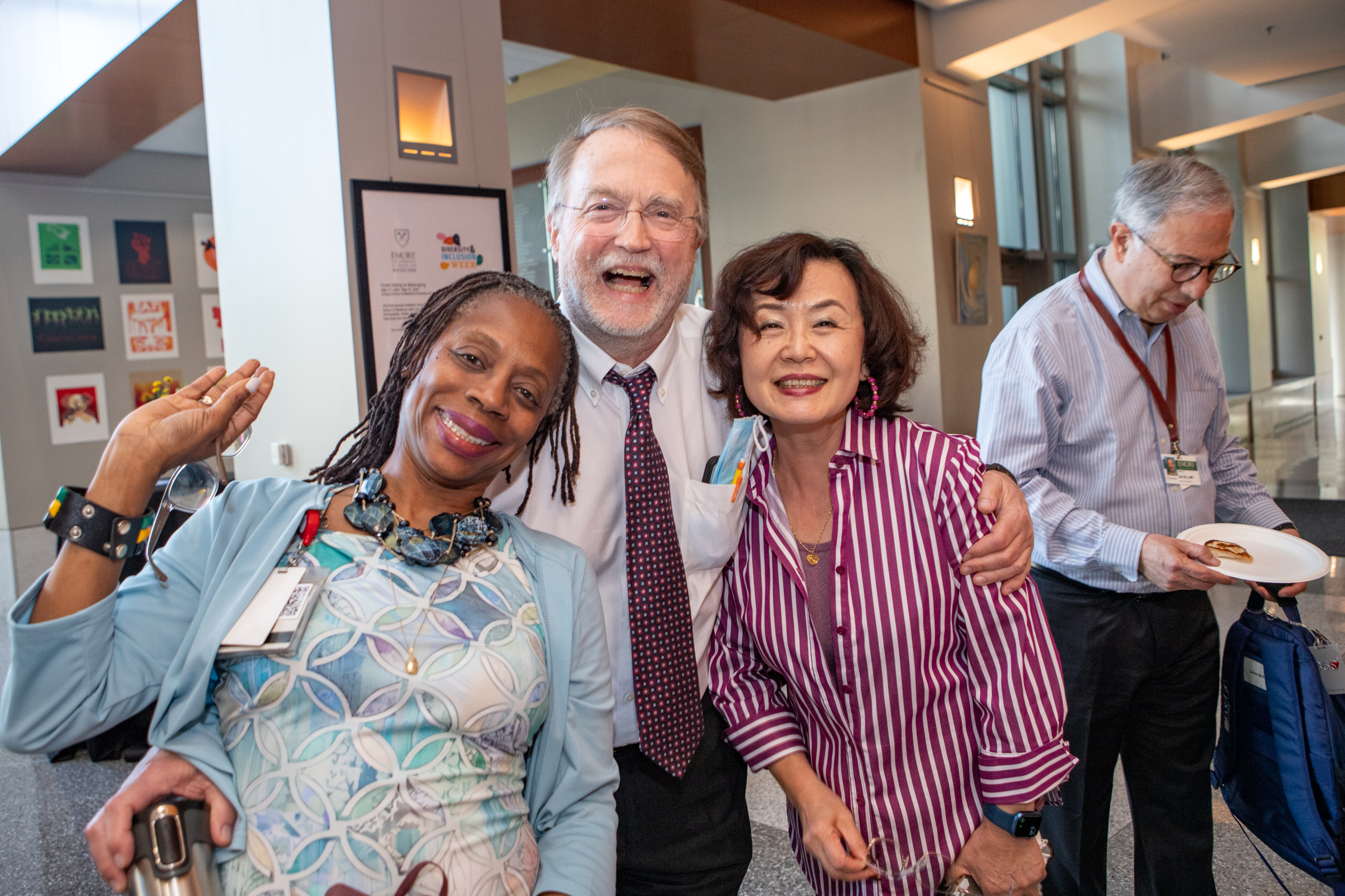 Three people smile for a photo.