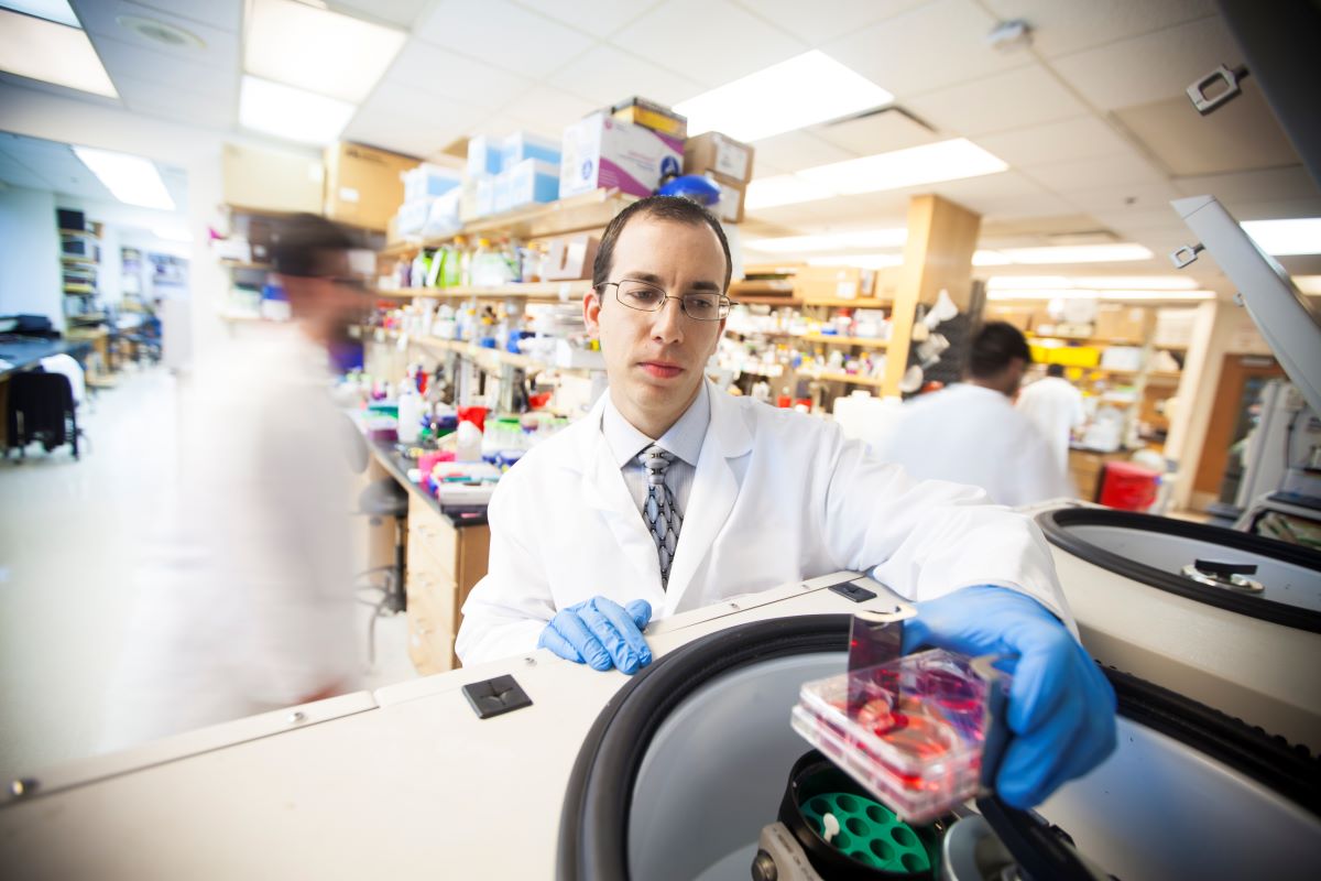 Faculty member doing research in a lab.
