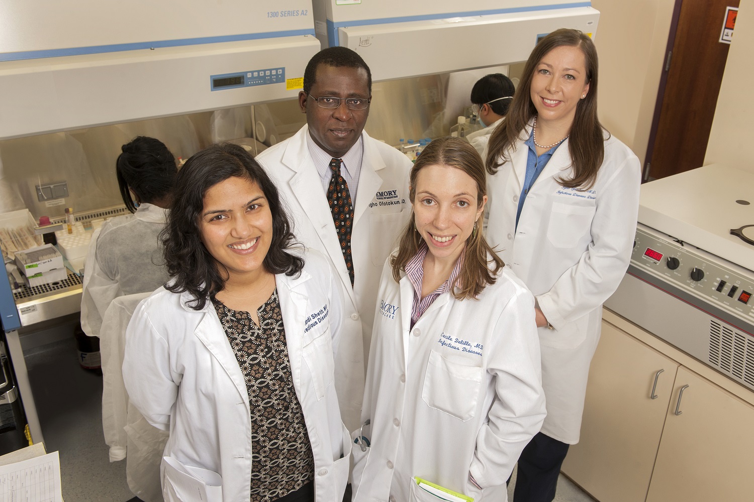 Faculty member with mentees in lab