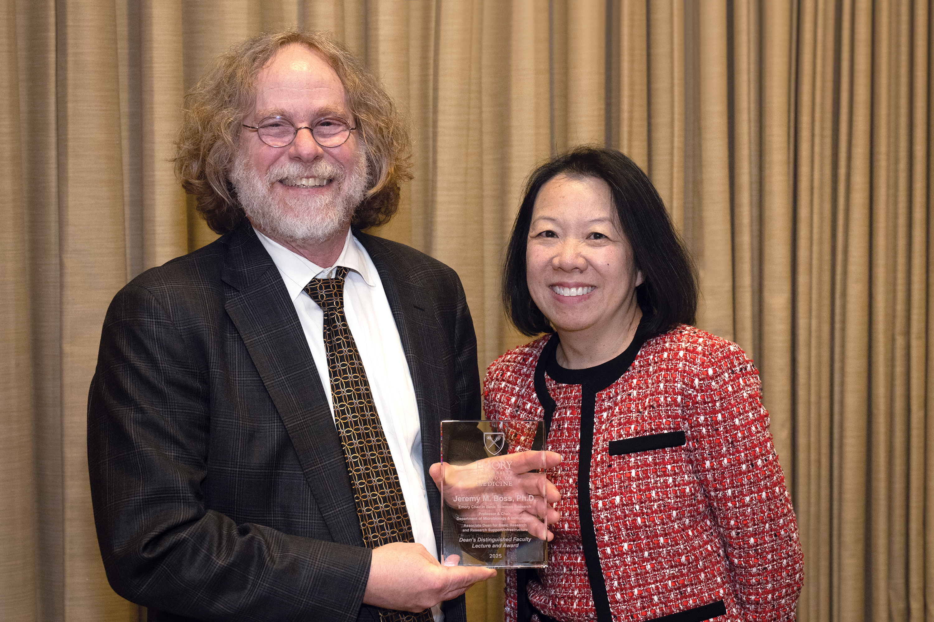 2025 winner Jeremey Boss holds award and smiles standing next to Dean Wong.