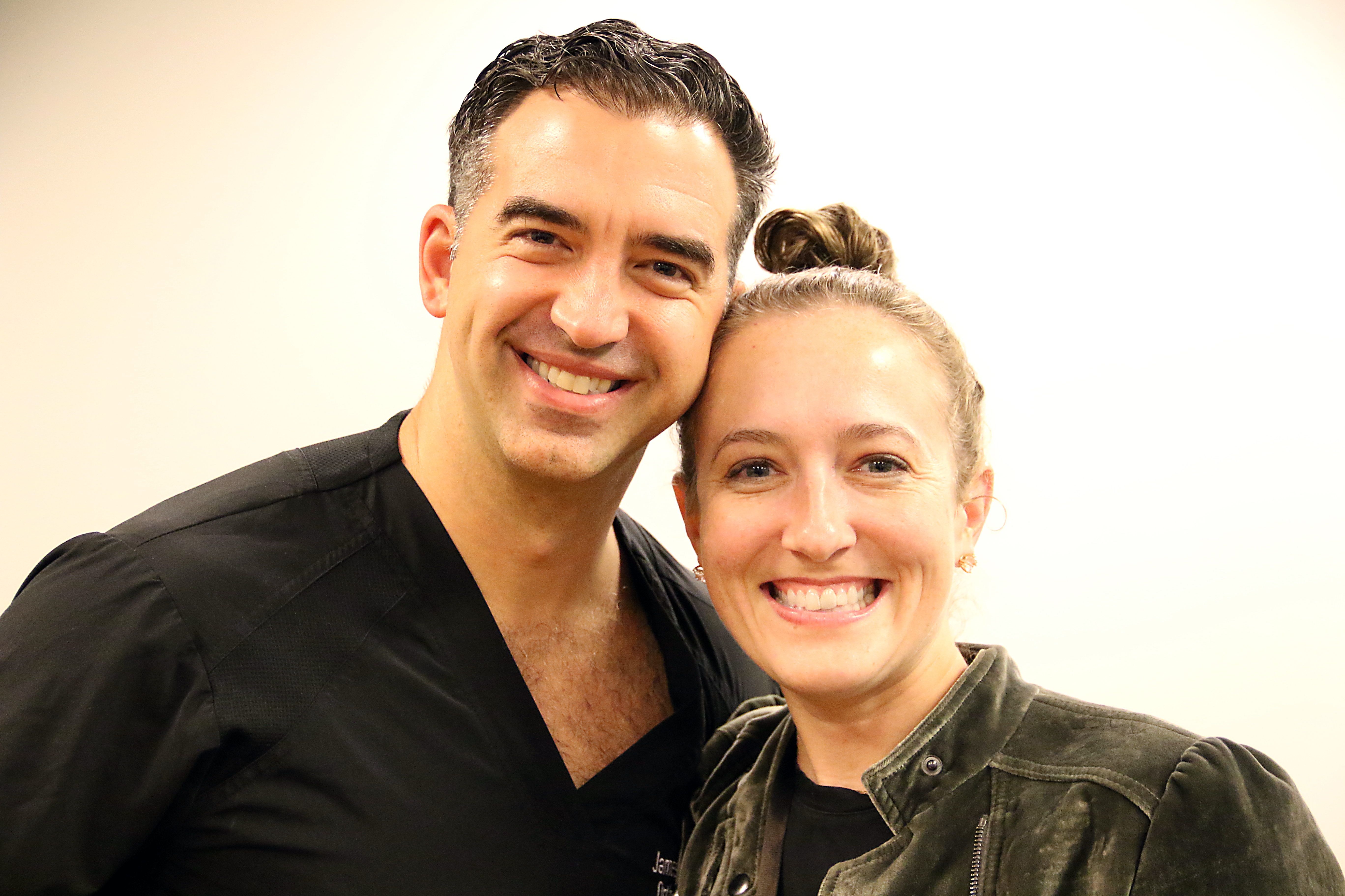 Two people smile for a photo. 