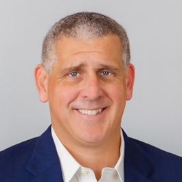 headshot of man in blue suit jacket