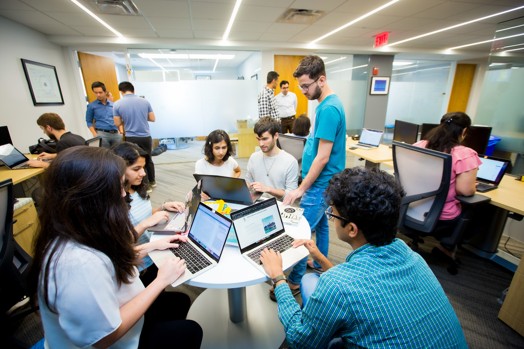 students with laptops in a circle