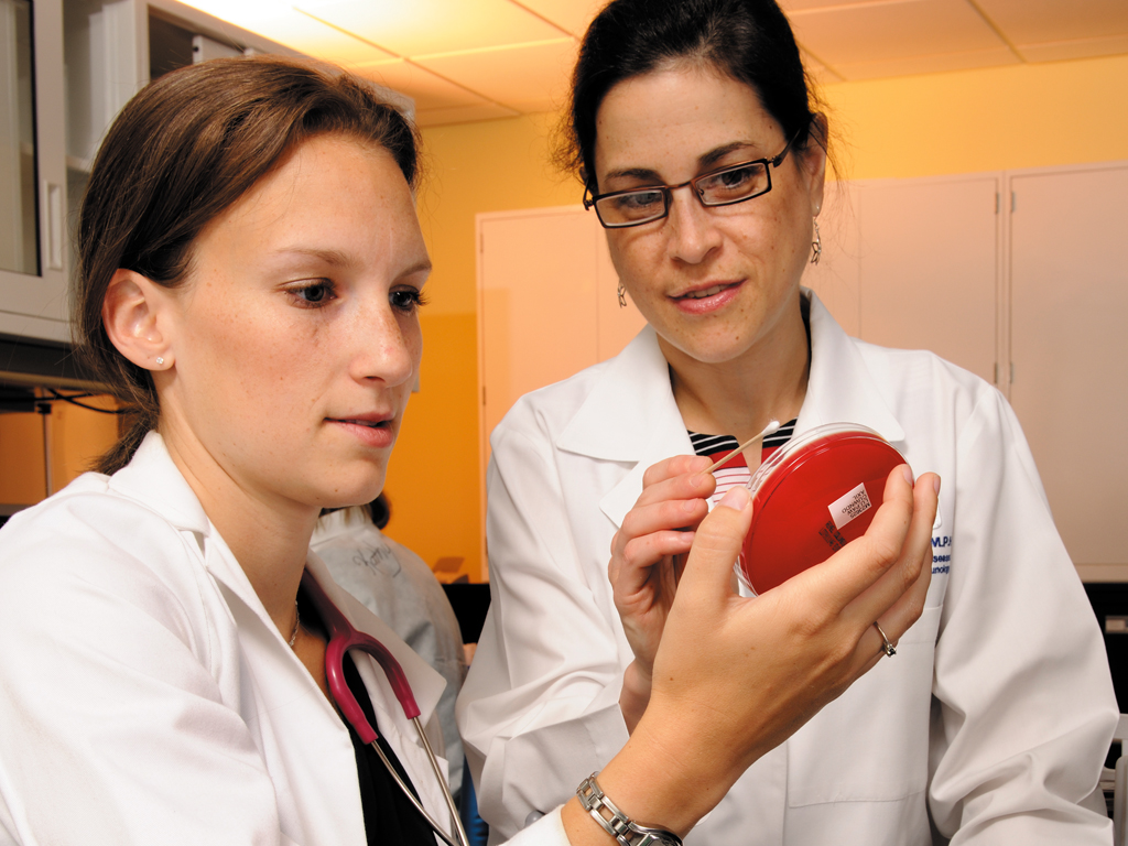 research investigator with student in lab