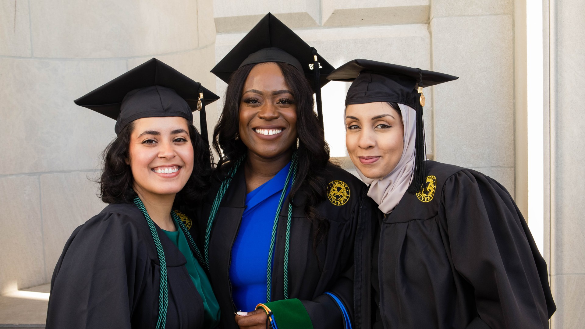 three PA program graduates in caps and gowns