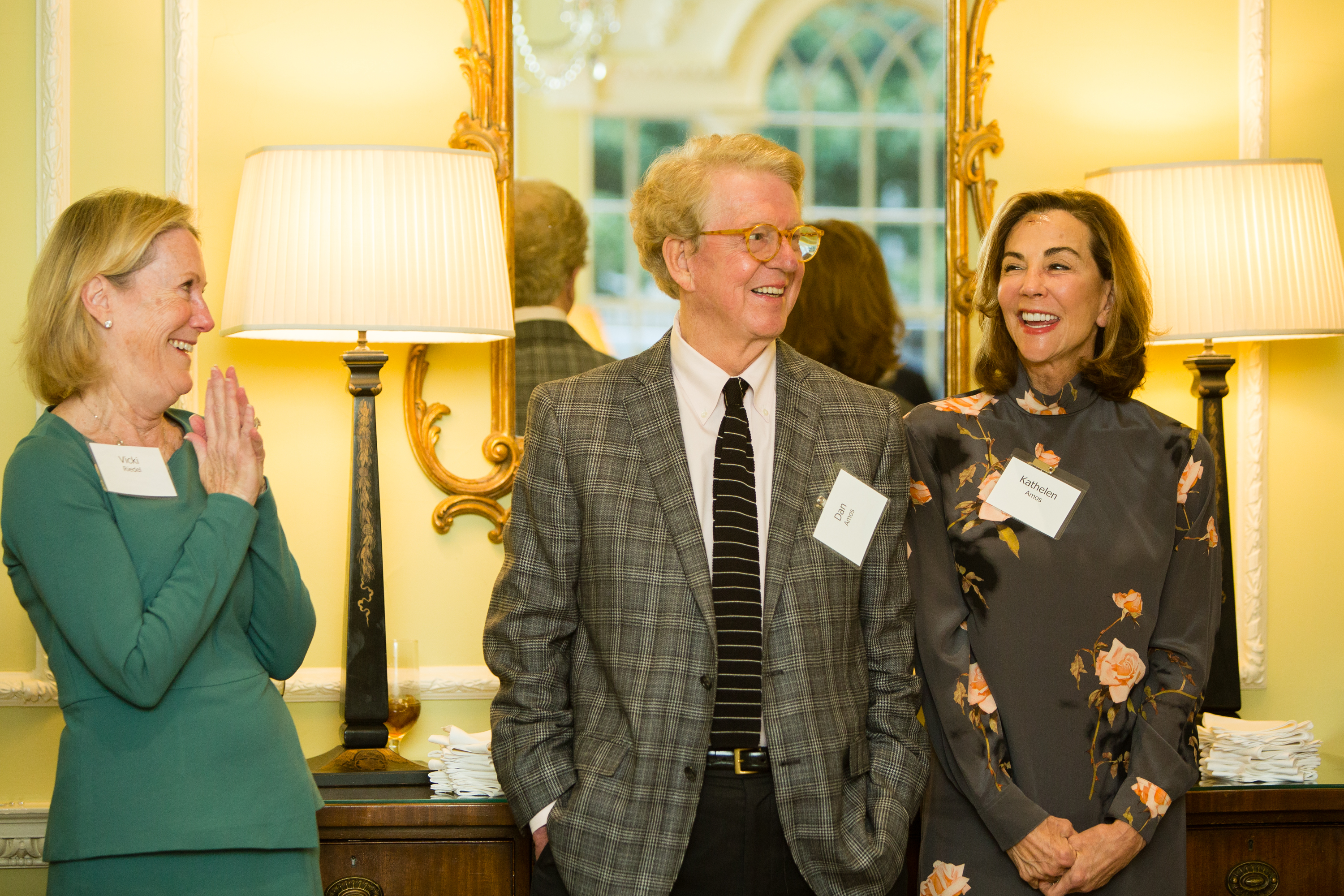 Image of three people smiling.