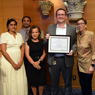 Jason Romancik, MD receiving H.J. Khoury Fellowship completion certificate.