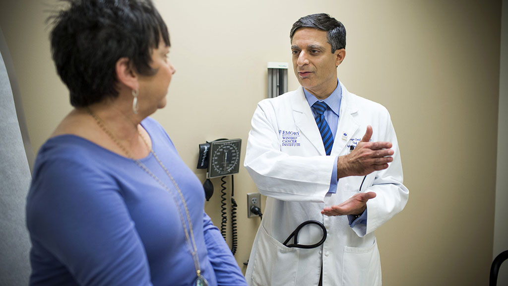 Dr. Sagar Lonial with patient in clinic room