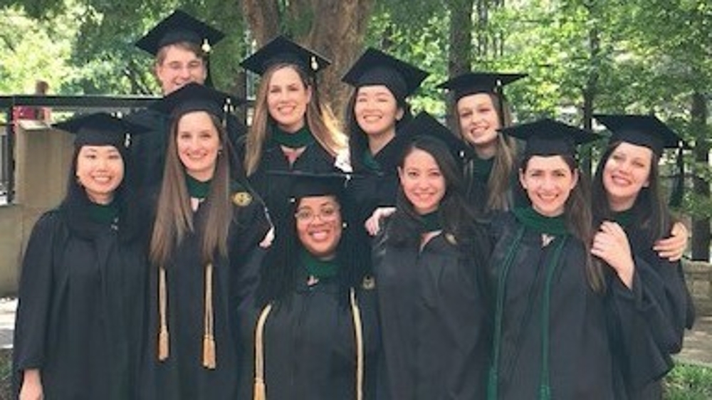 2018 graduates posing in their robes