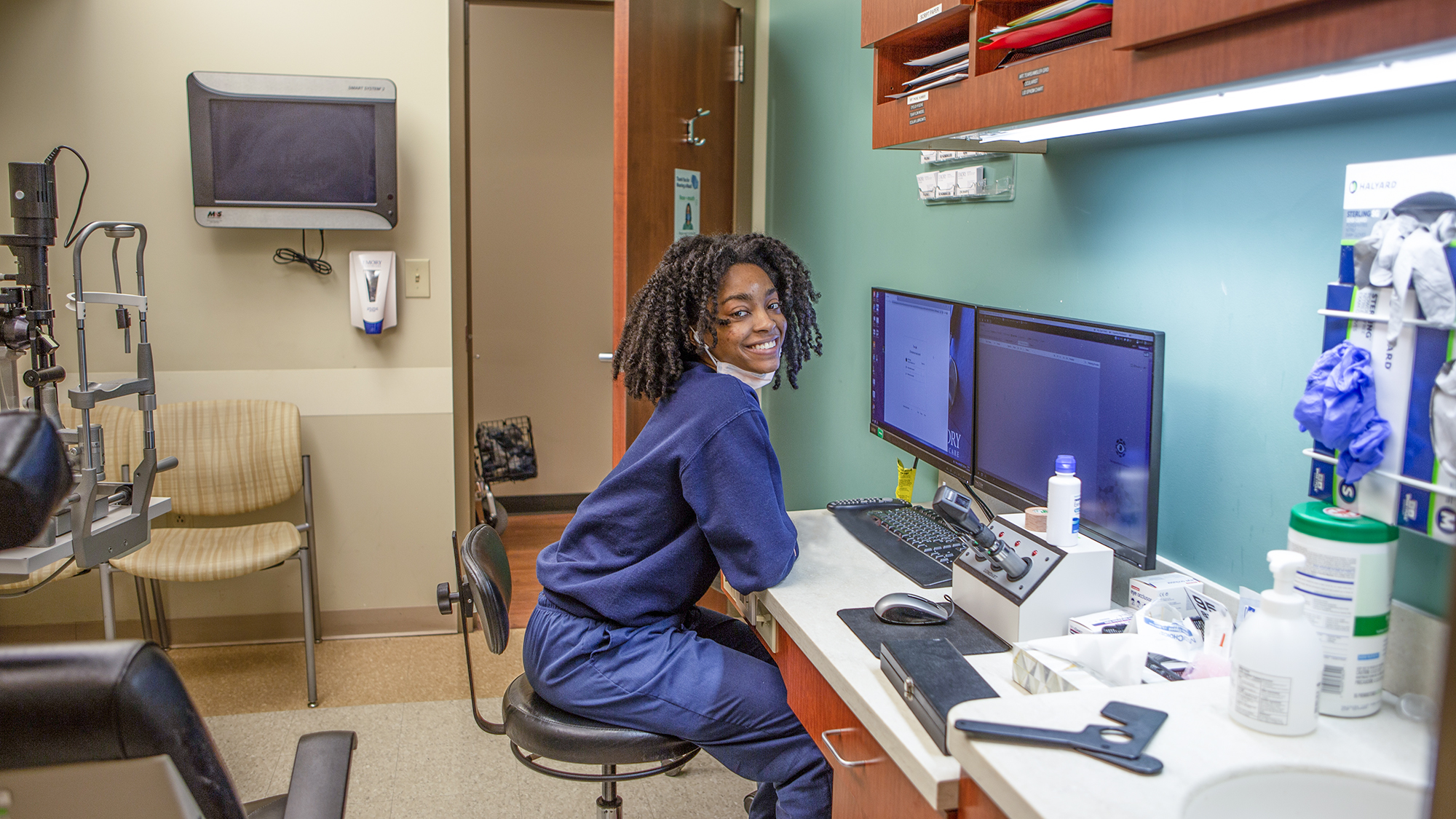 Patient care tech looking up from her computer