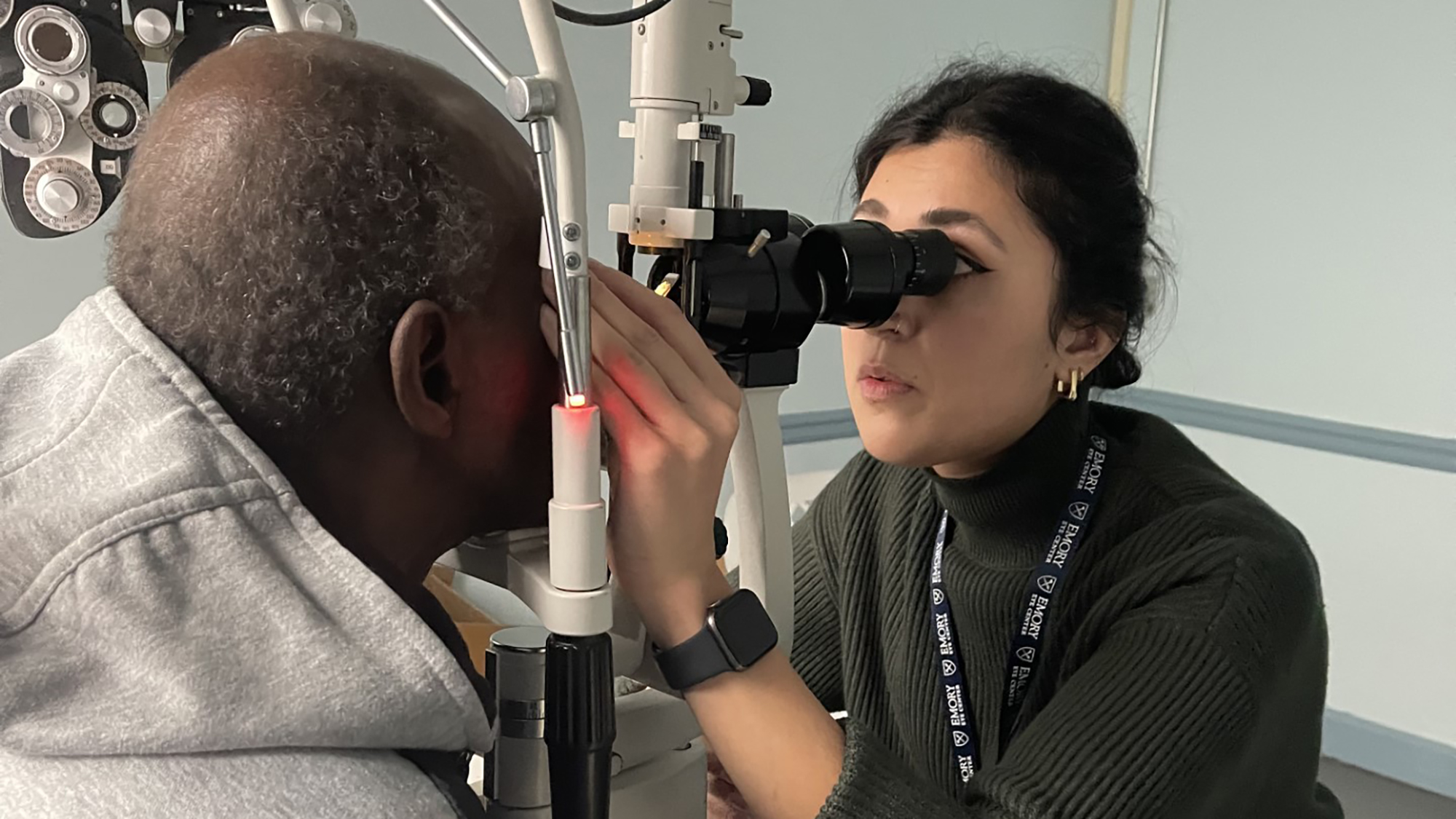 Physician giving a female patient an acuity test