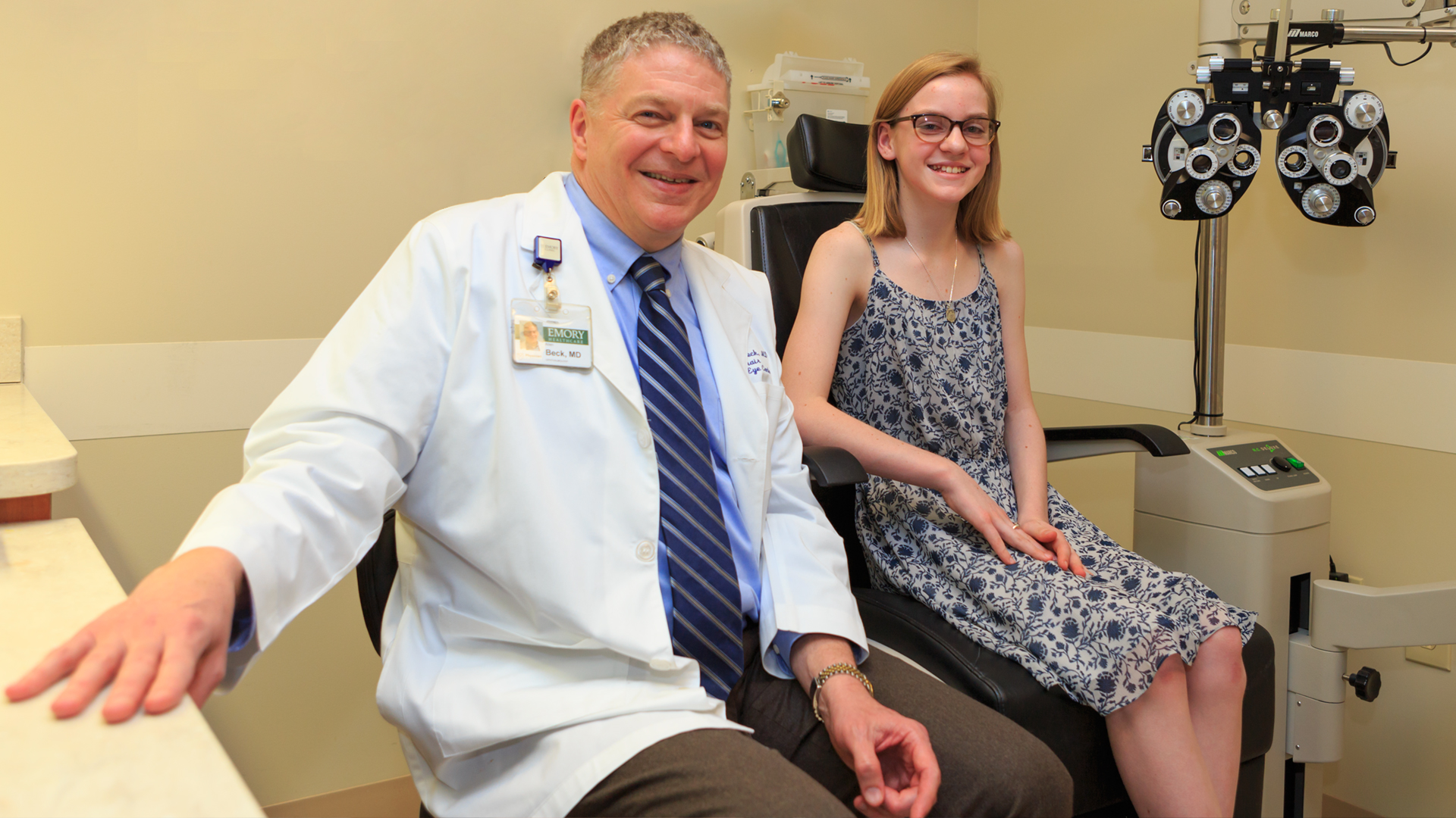 Dr. Allen Beck and a patient take a moment from an eye exam to visit with the photographer