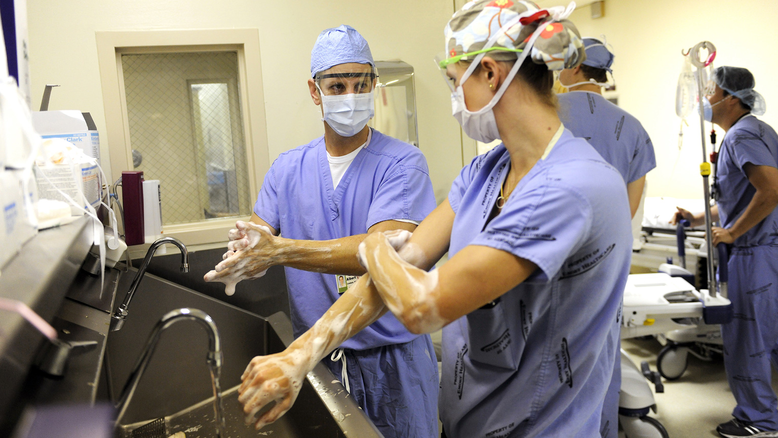 Faculty surgeon prepping for the OR with a resident.