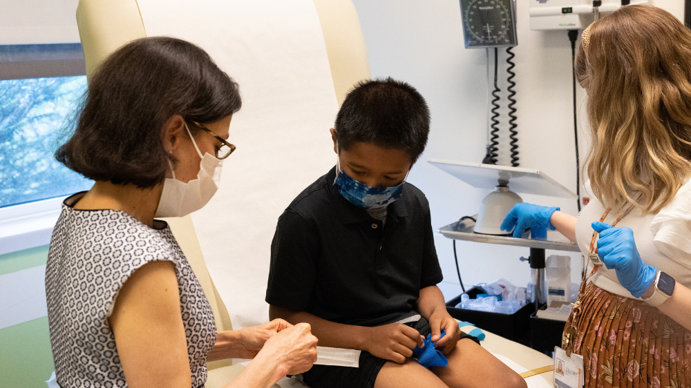 Two Infectious Disease doctors examining a young patient at the doctor's office