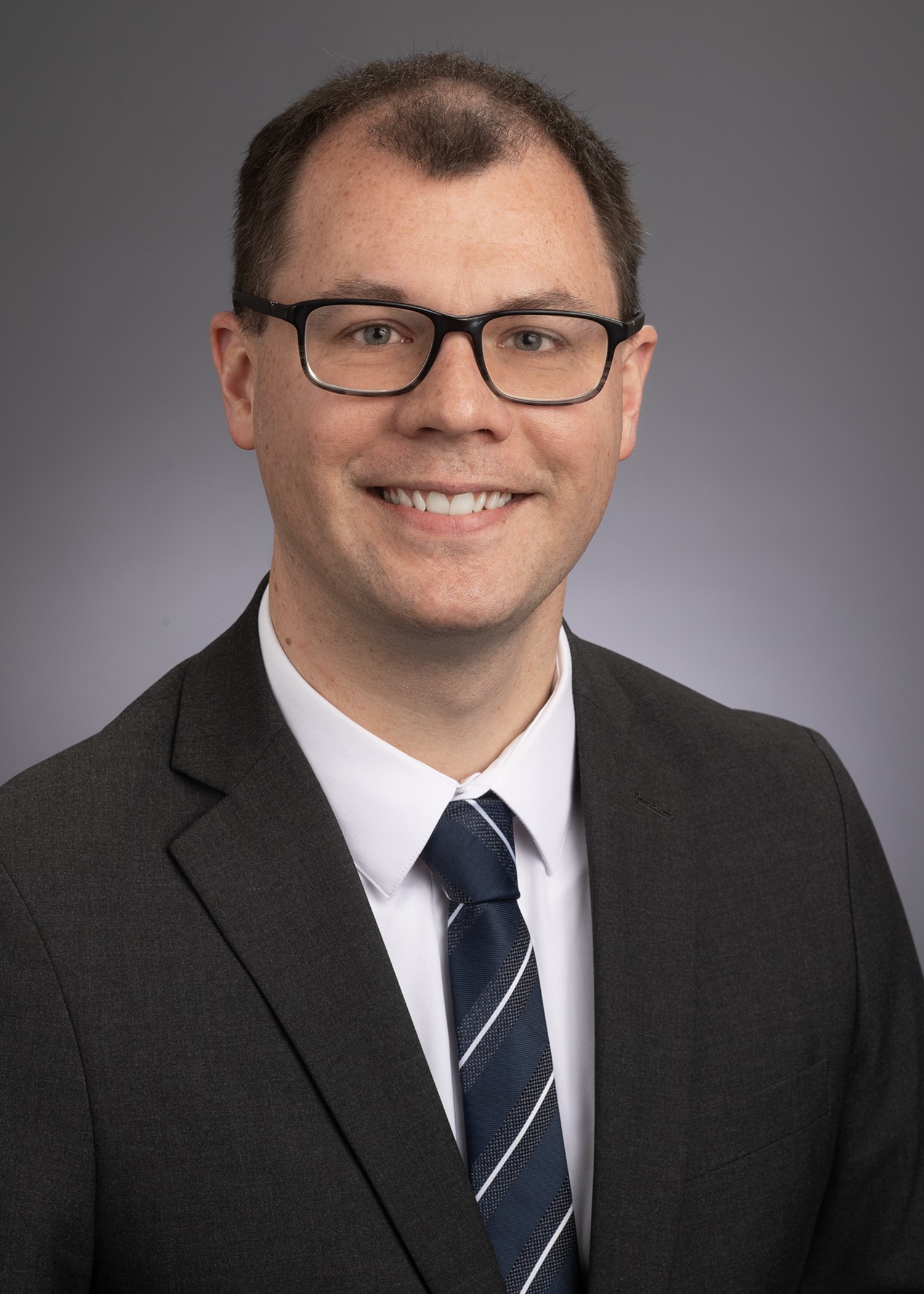 headshot of man in a suit