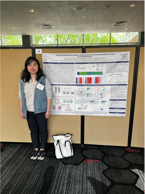 woman standing in front of her poster presentation