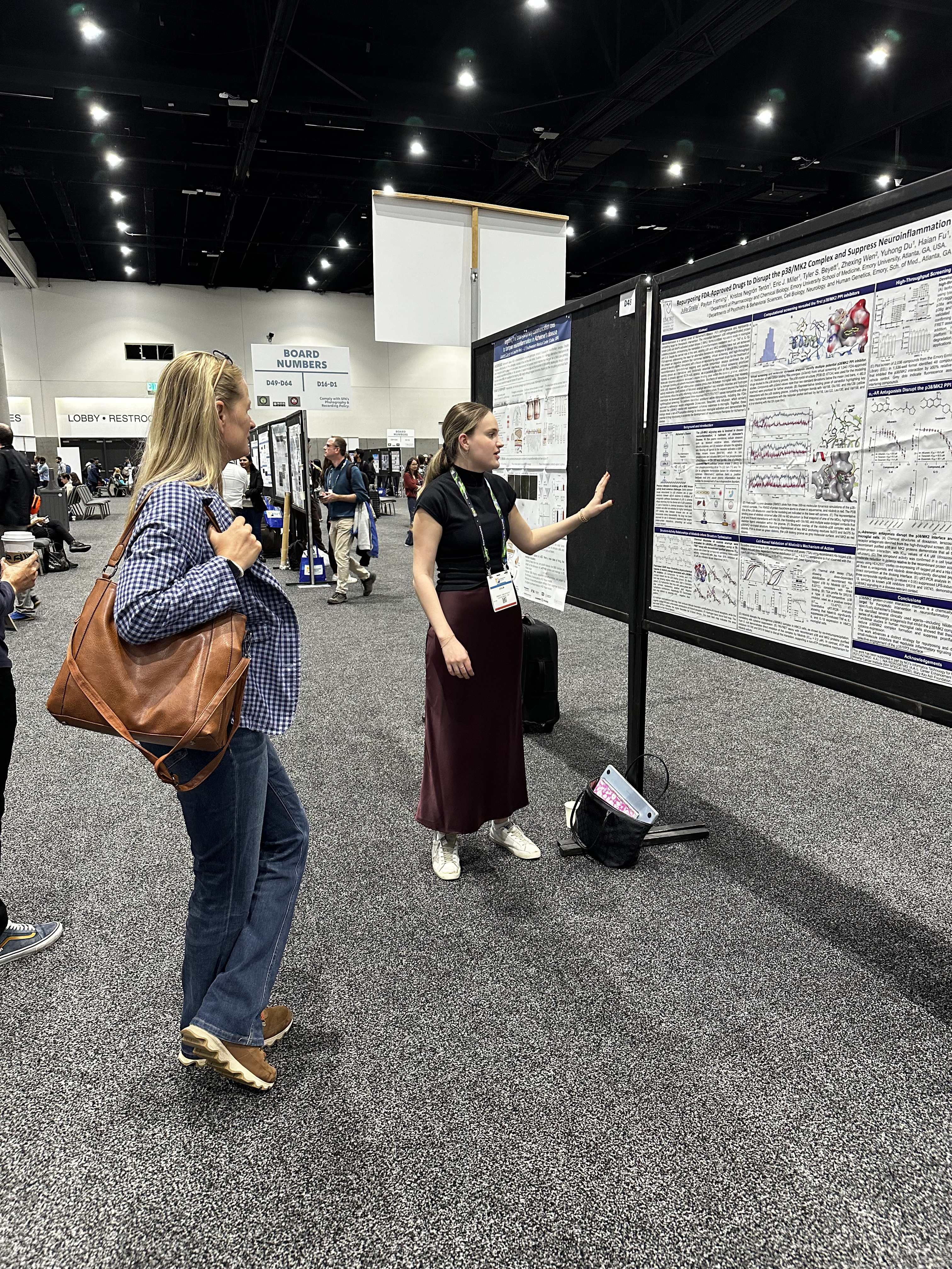 woman standing next to display board