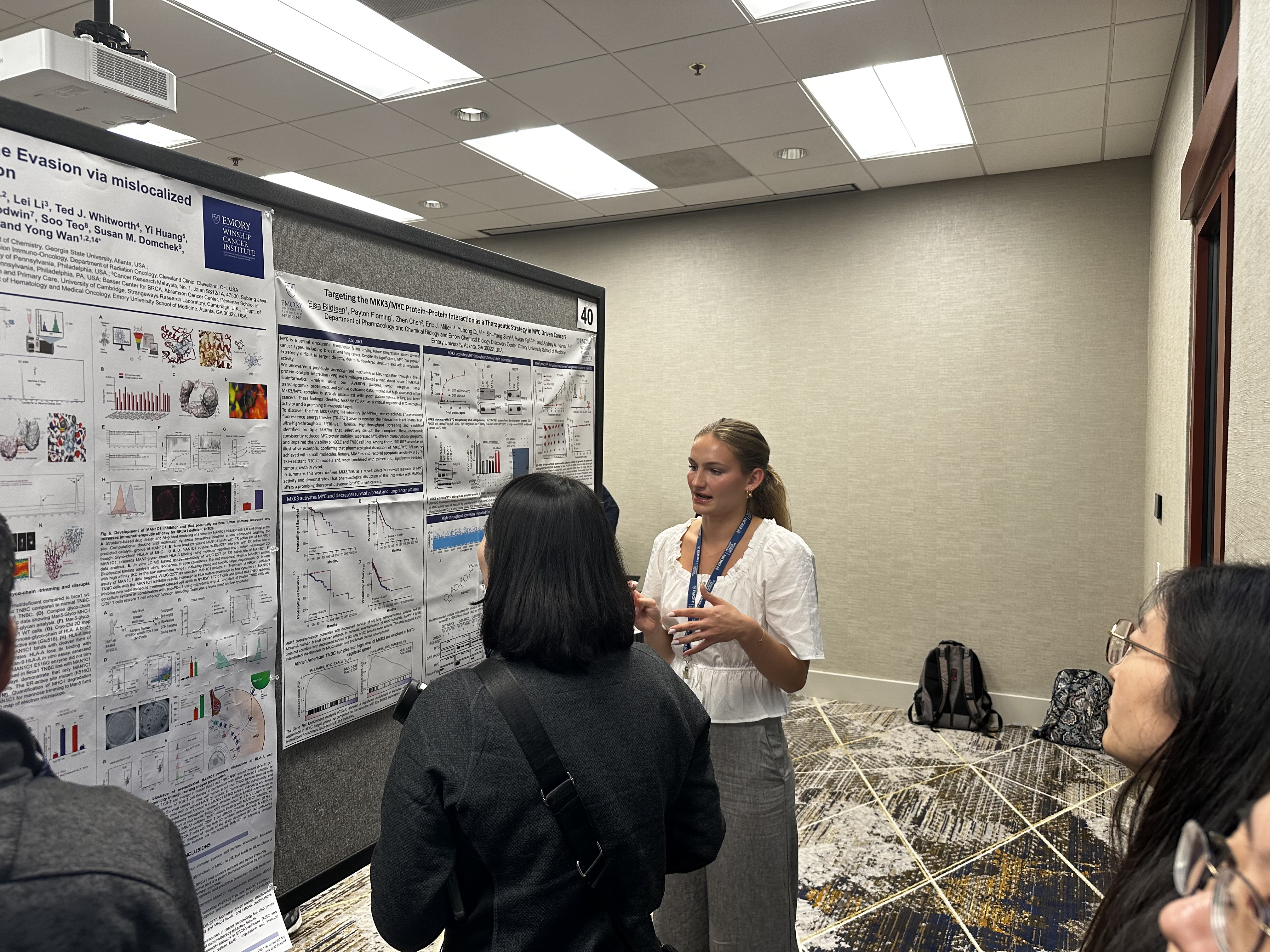 woman standing at presentation poster board