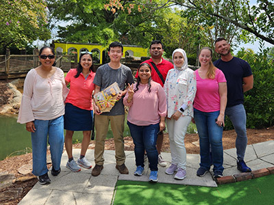 Kesarawala and Orthwein lab teams during a putt putt golf outing.