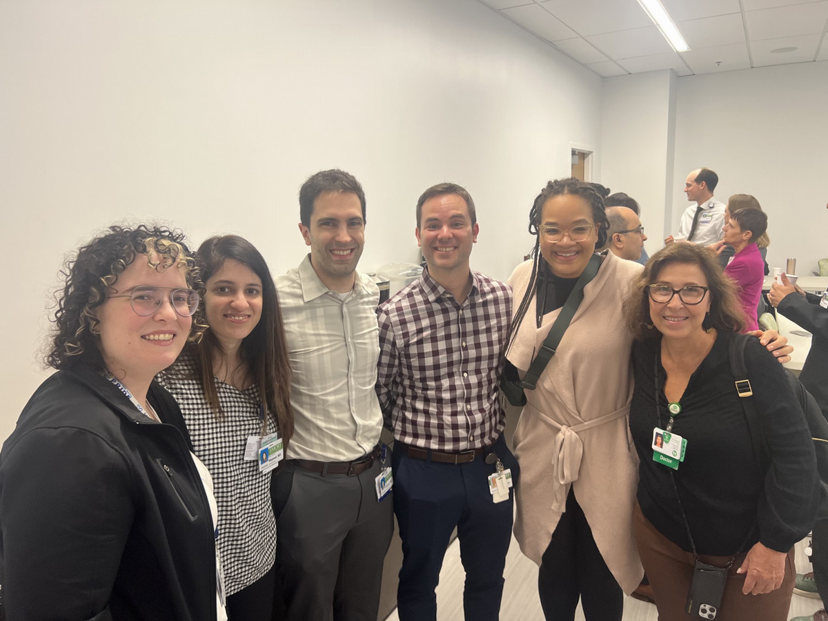group of people standing in a line smiling