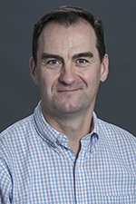 white man with brown hair smiling