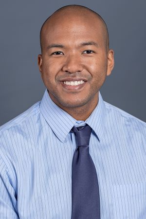 smiling person wearing a blue shirt