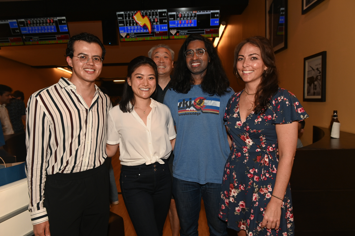 smiling people looking at camera in a bowling alley