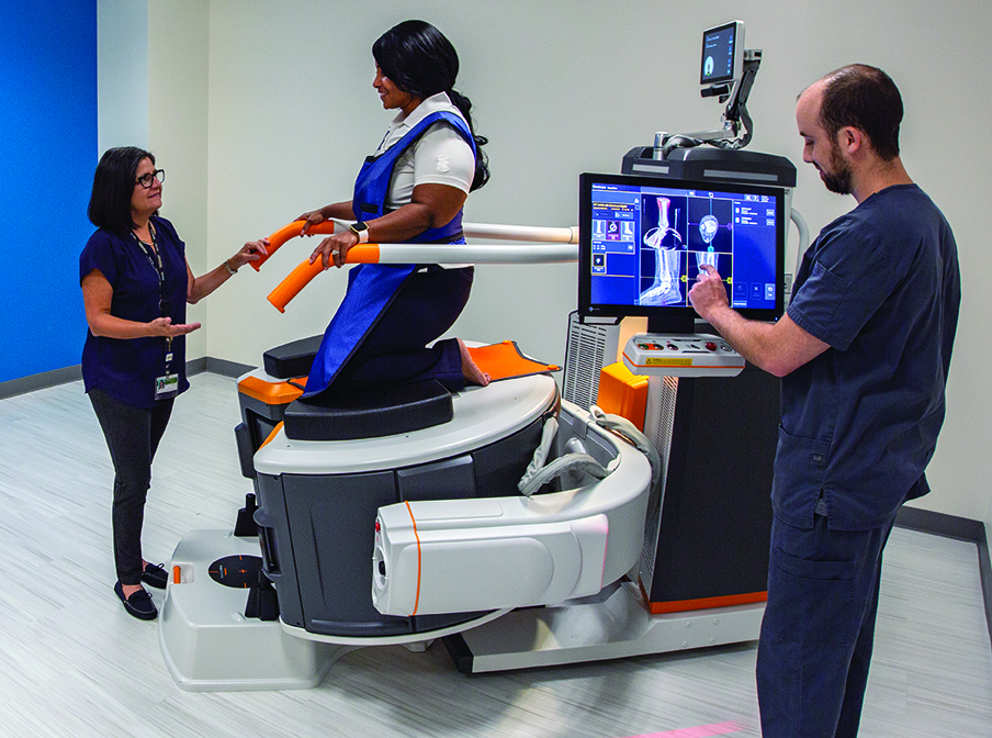 person helped into cone beam CT scanner w/technologist taking images