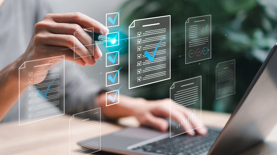 graphic of person's hands checking boxes and working at a computer