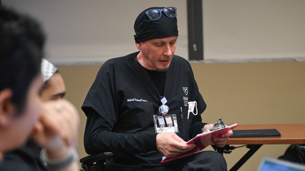 student reading from book to class