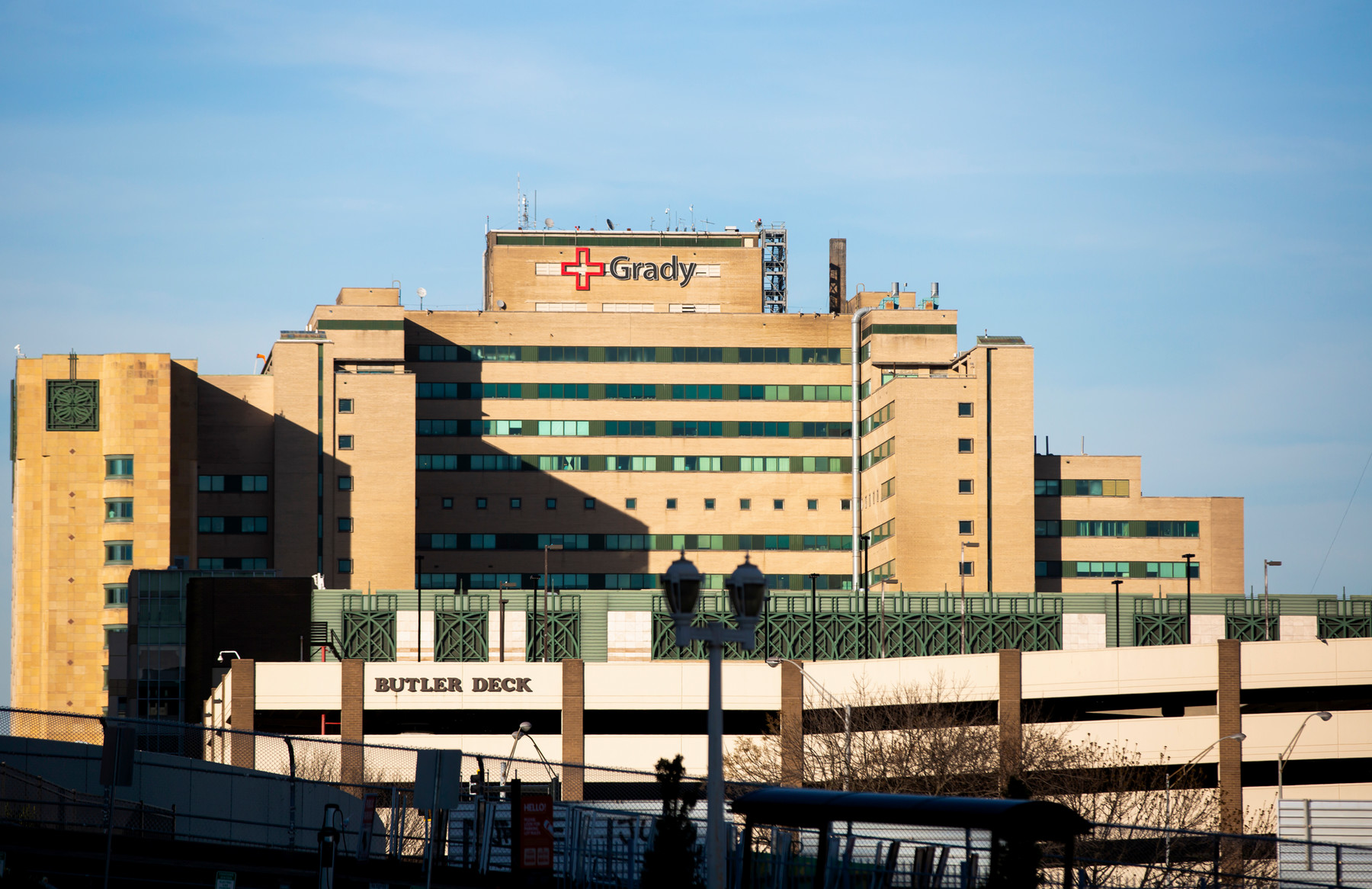large hospital building with tan exterior + sign saying Grady