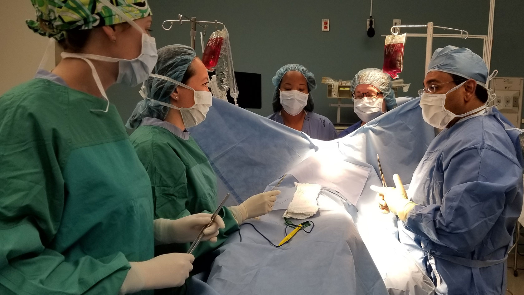 Surgical team doing simulation training emergency scenario.