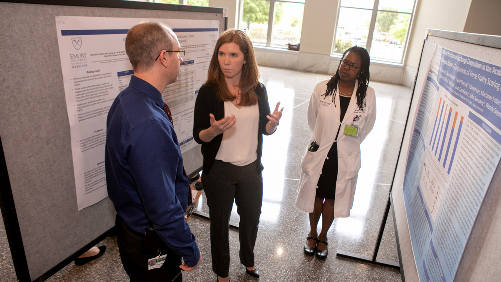 Presenting research at a poster session.